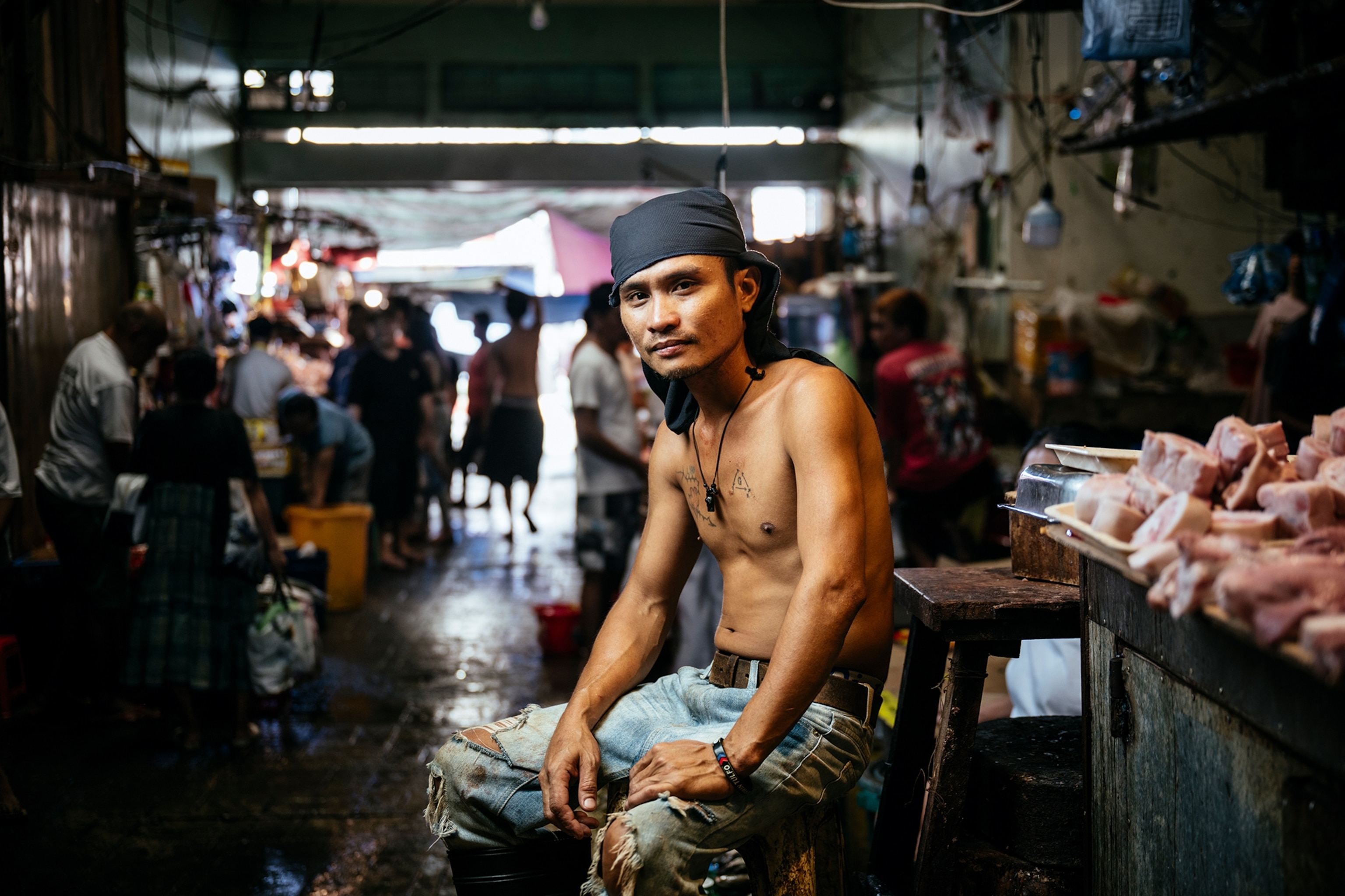 A young male street seller in front of his stall.