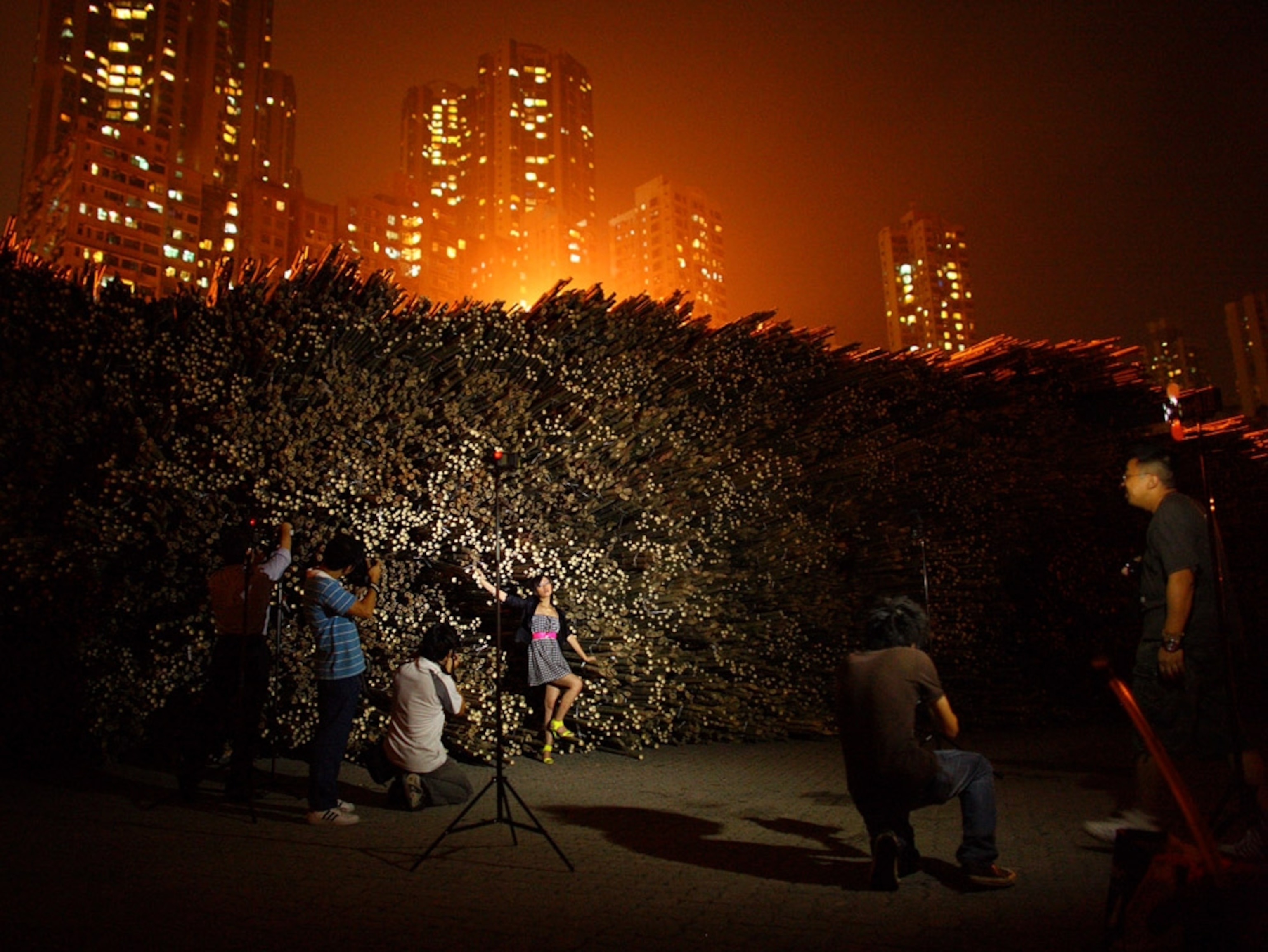 Photographers and a model at night