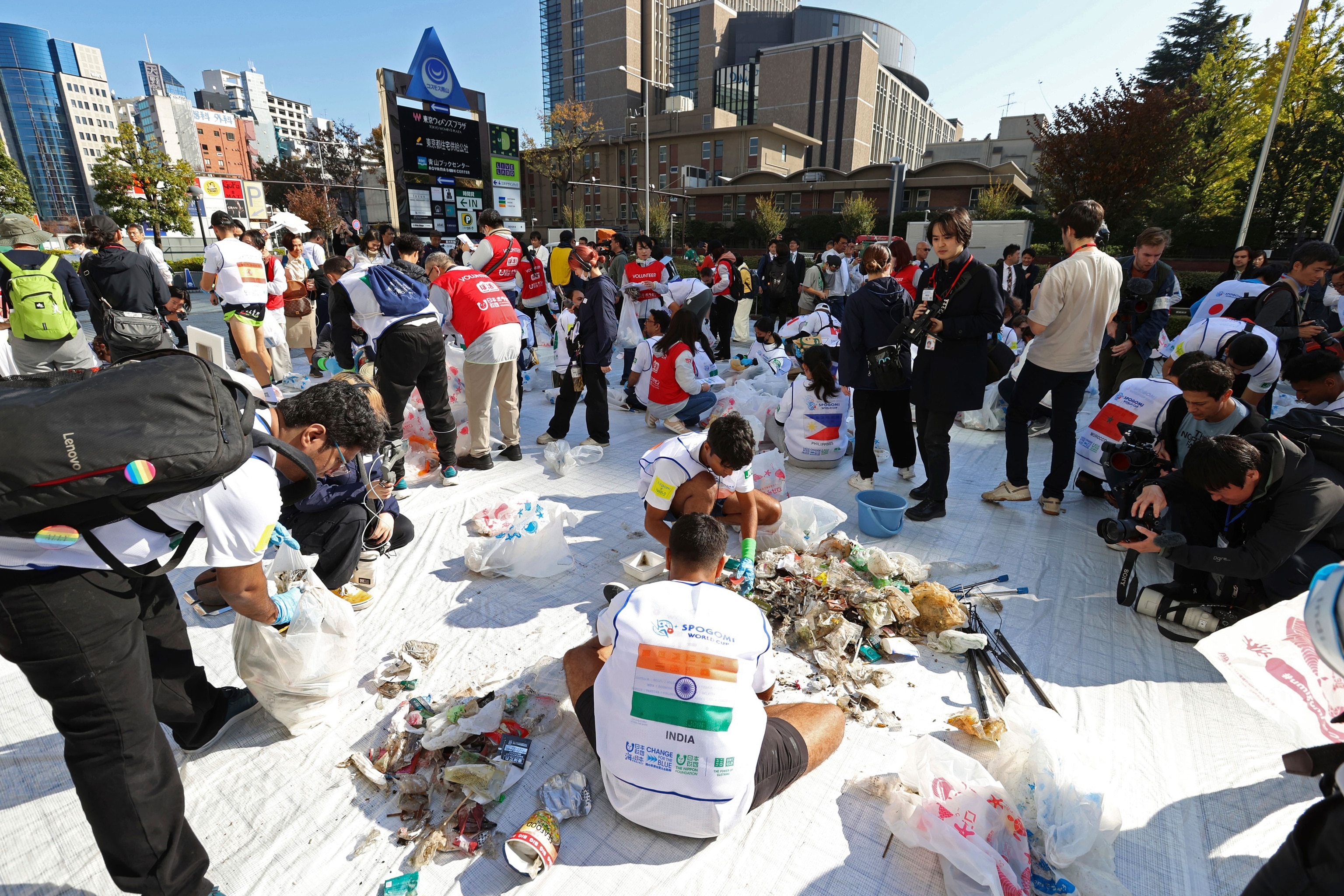 Participants sort through what the trash they collected during the SPOGOMI World Cup in Shibuya Ward, Tokyo.