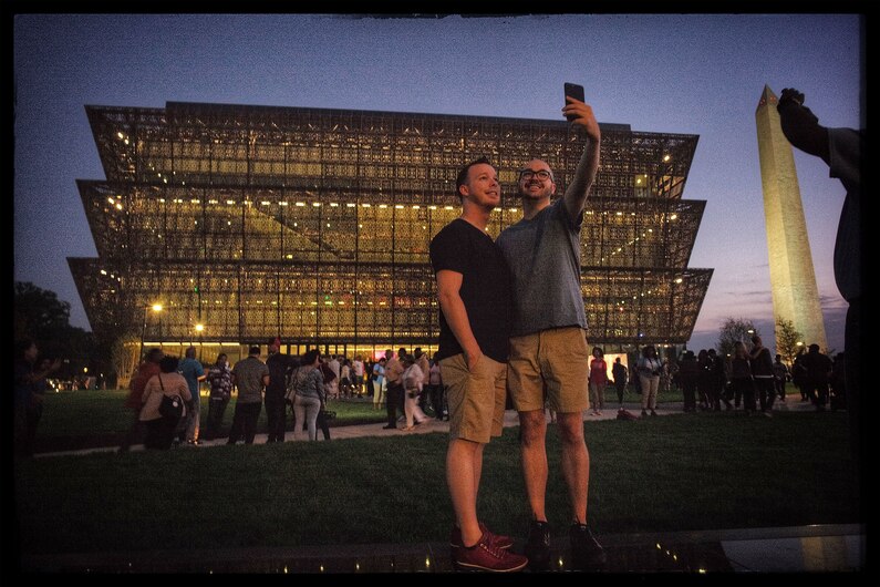 Aaron Dawson (with cellphone) and his friend said they have not been able to get inside the museum yet but are hoping that they will soon. In the meantime they are happy to take selfies in front of the structure.
