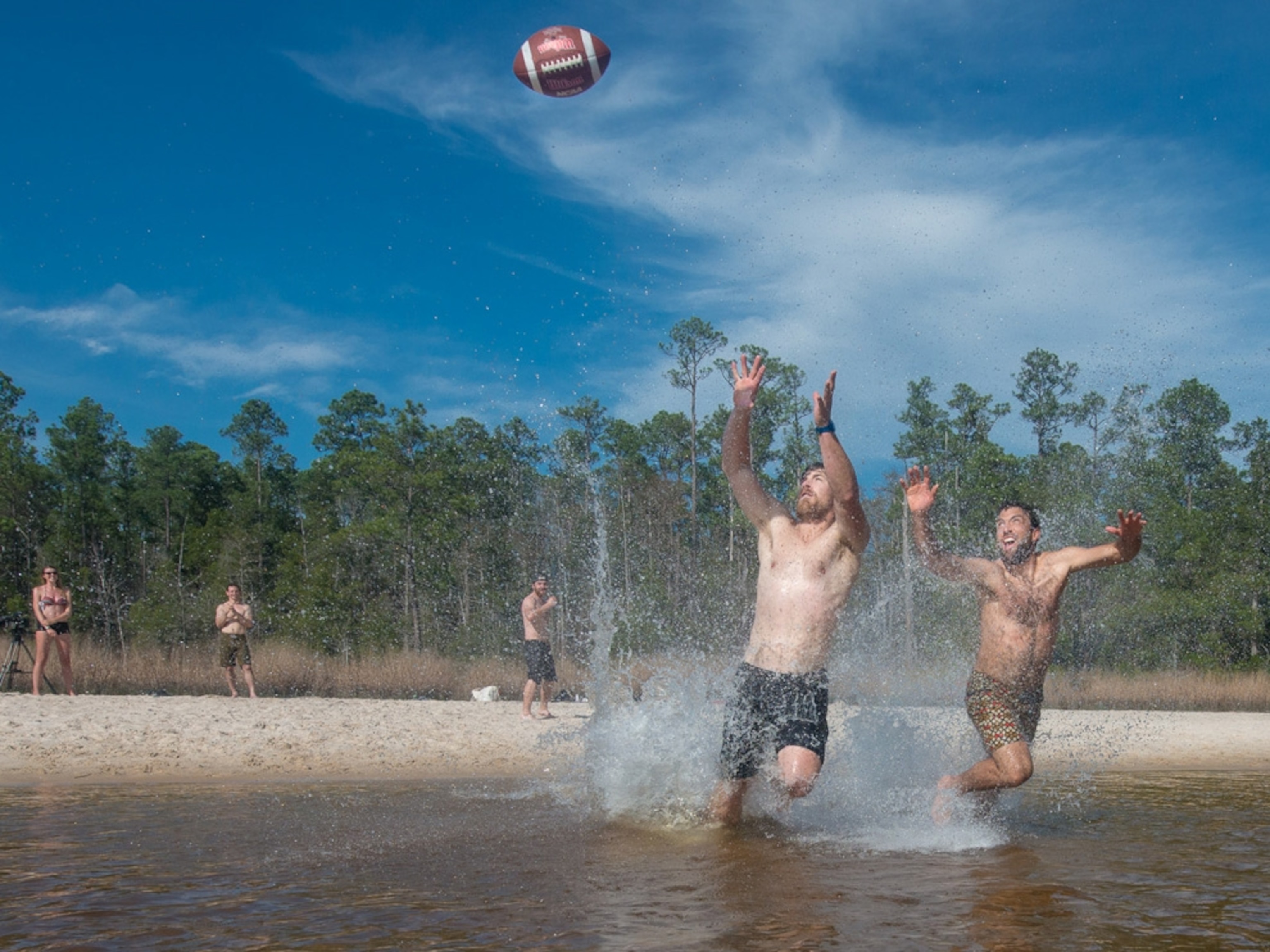 men playing football in the Blackwater River, Florida