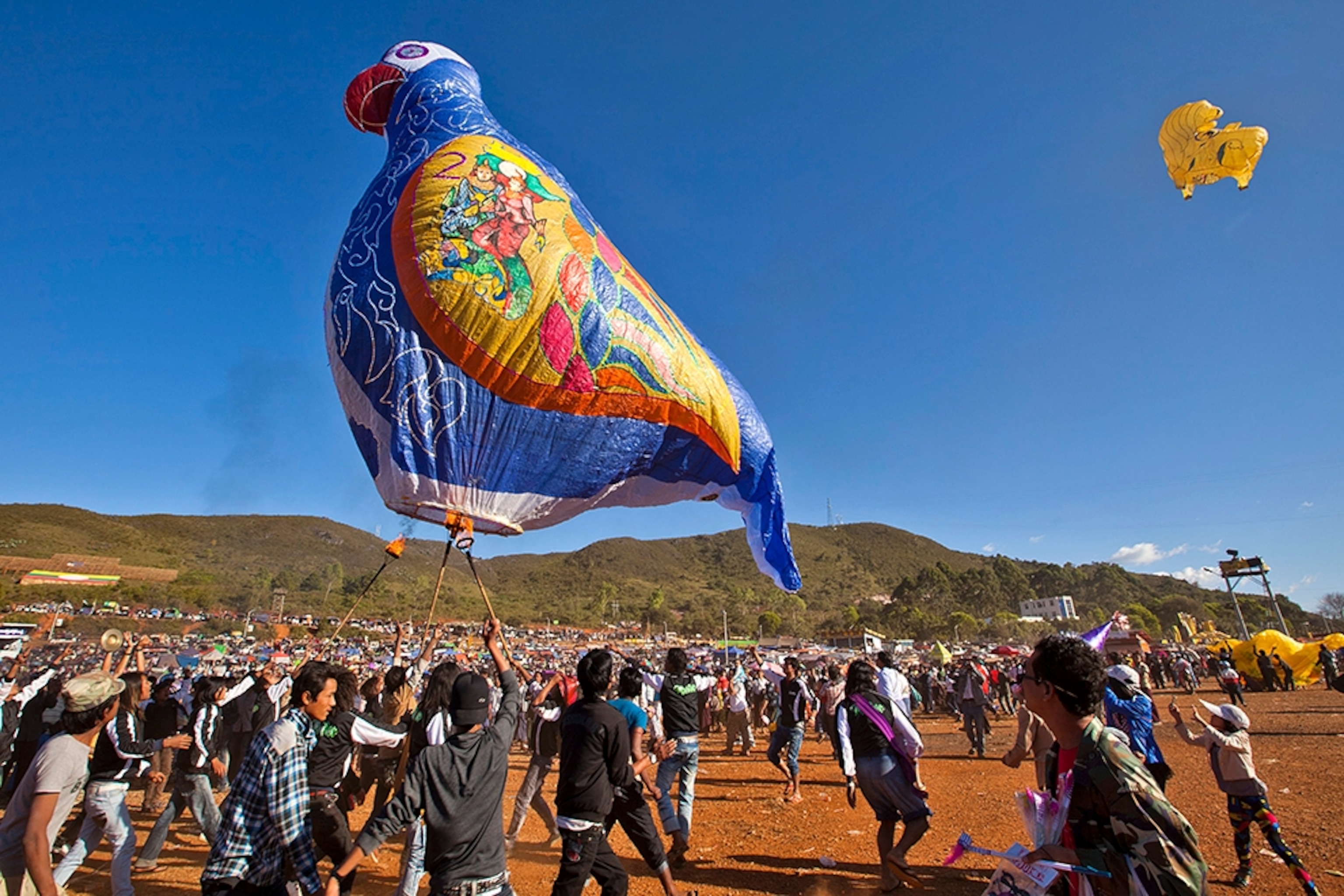people lighting a hot air balloon at the Taunggyi Balloon Festival in Mayanmar
