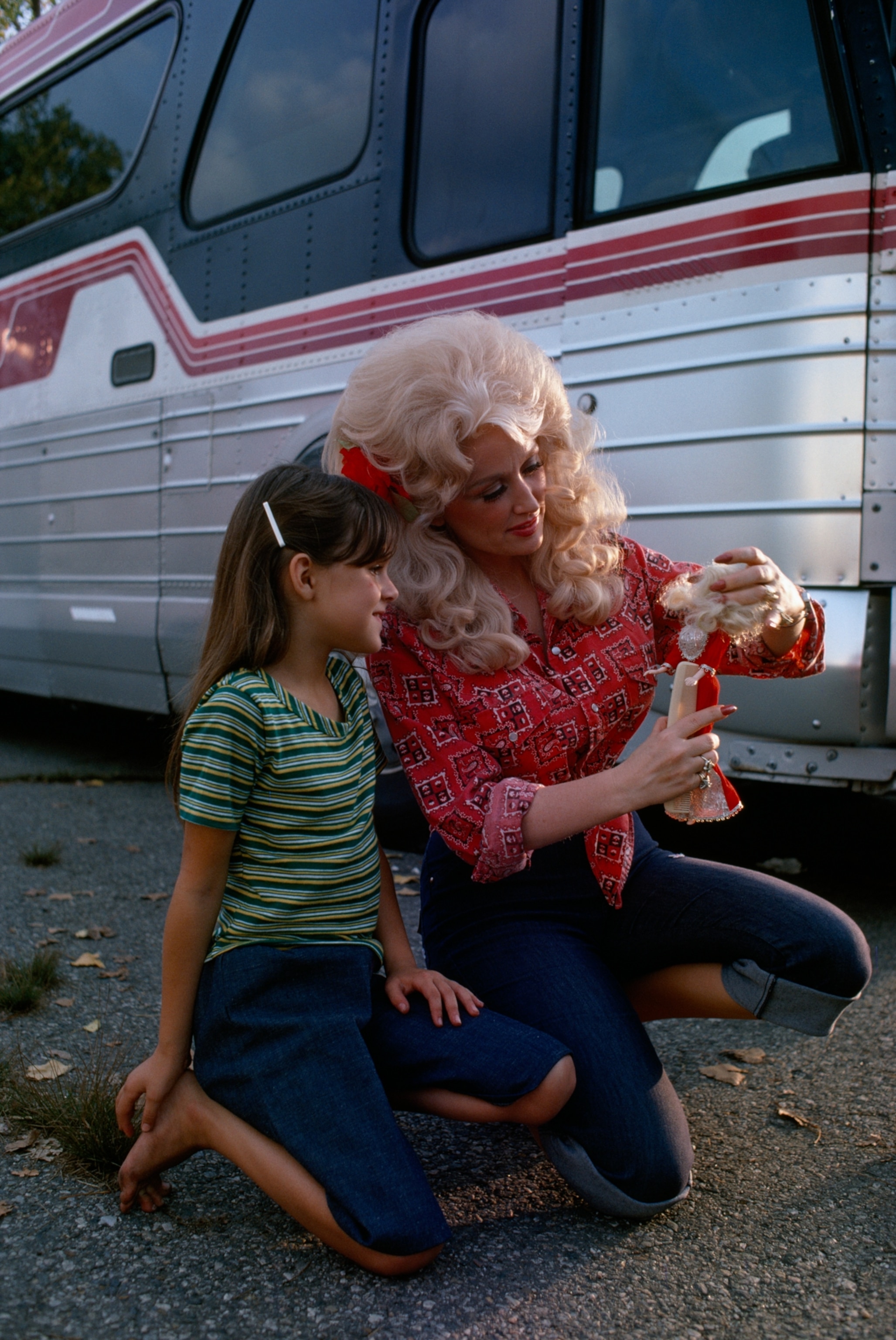 Country music star Dolly Parton meets a fan with a Dolly doll.