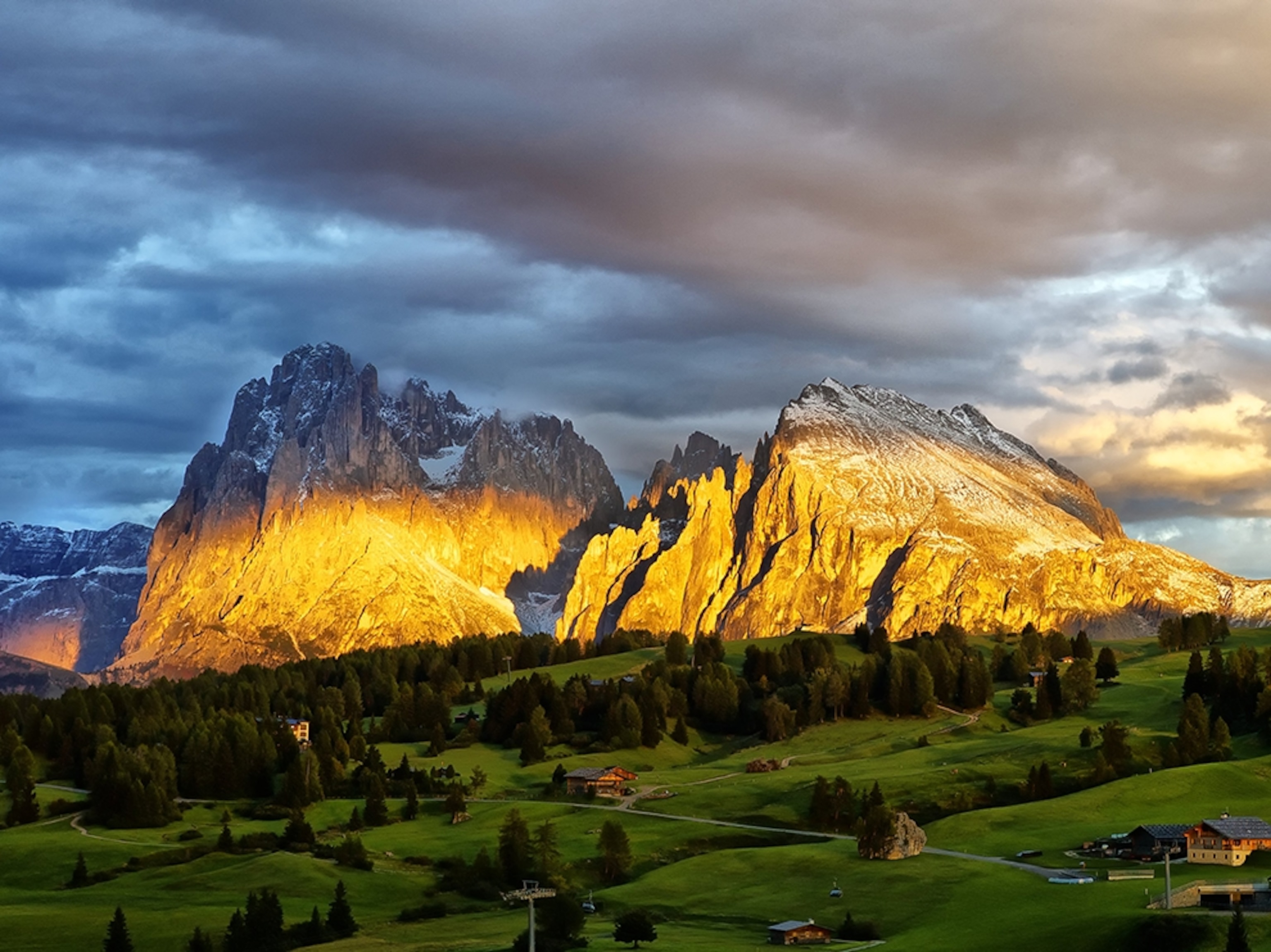 sunlight striking the Dolomite Mountains, Italy