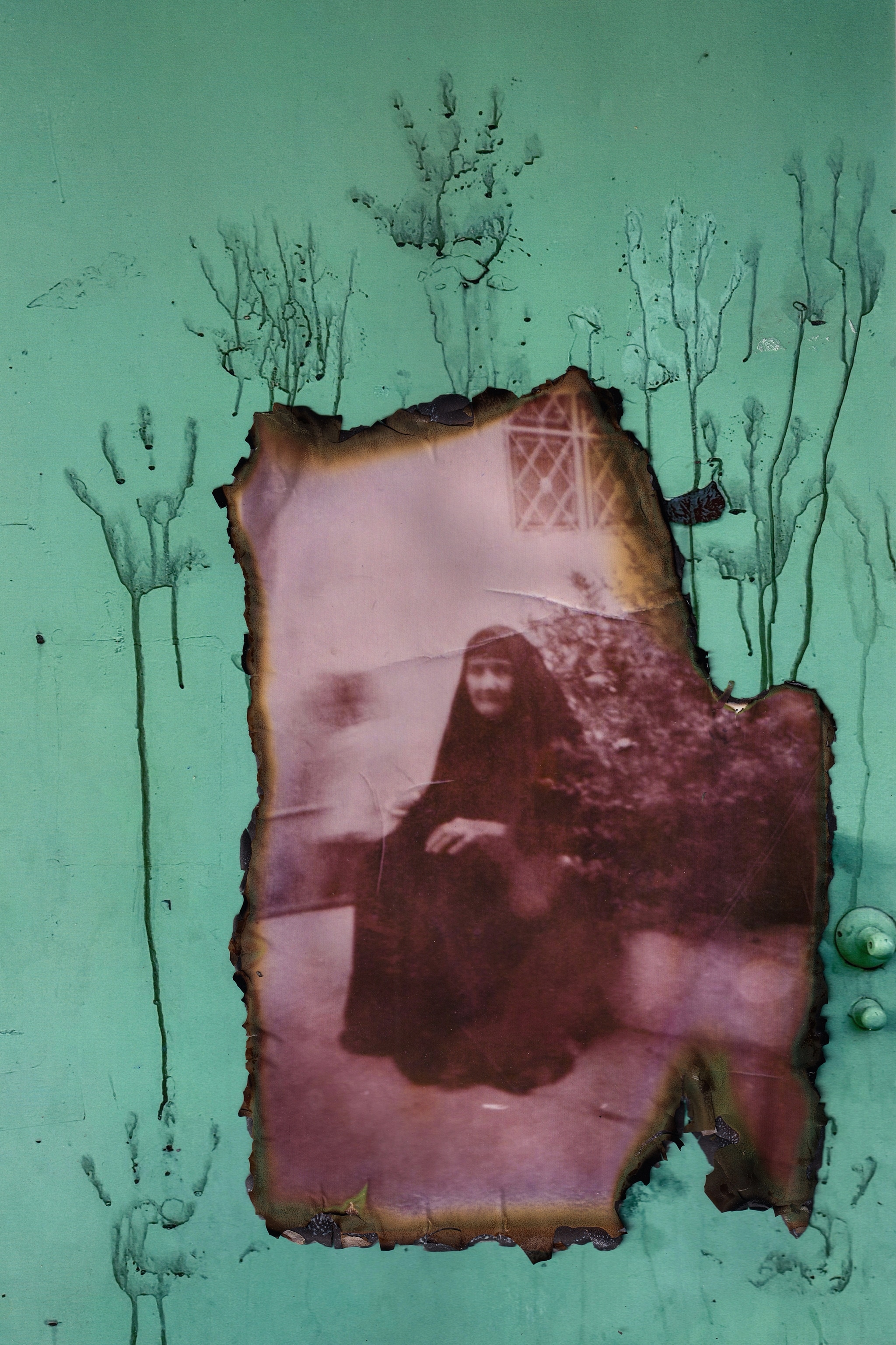 A sepia-toned photo of an elderly woman sitting on a chair imposed over a green wall with red handprints