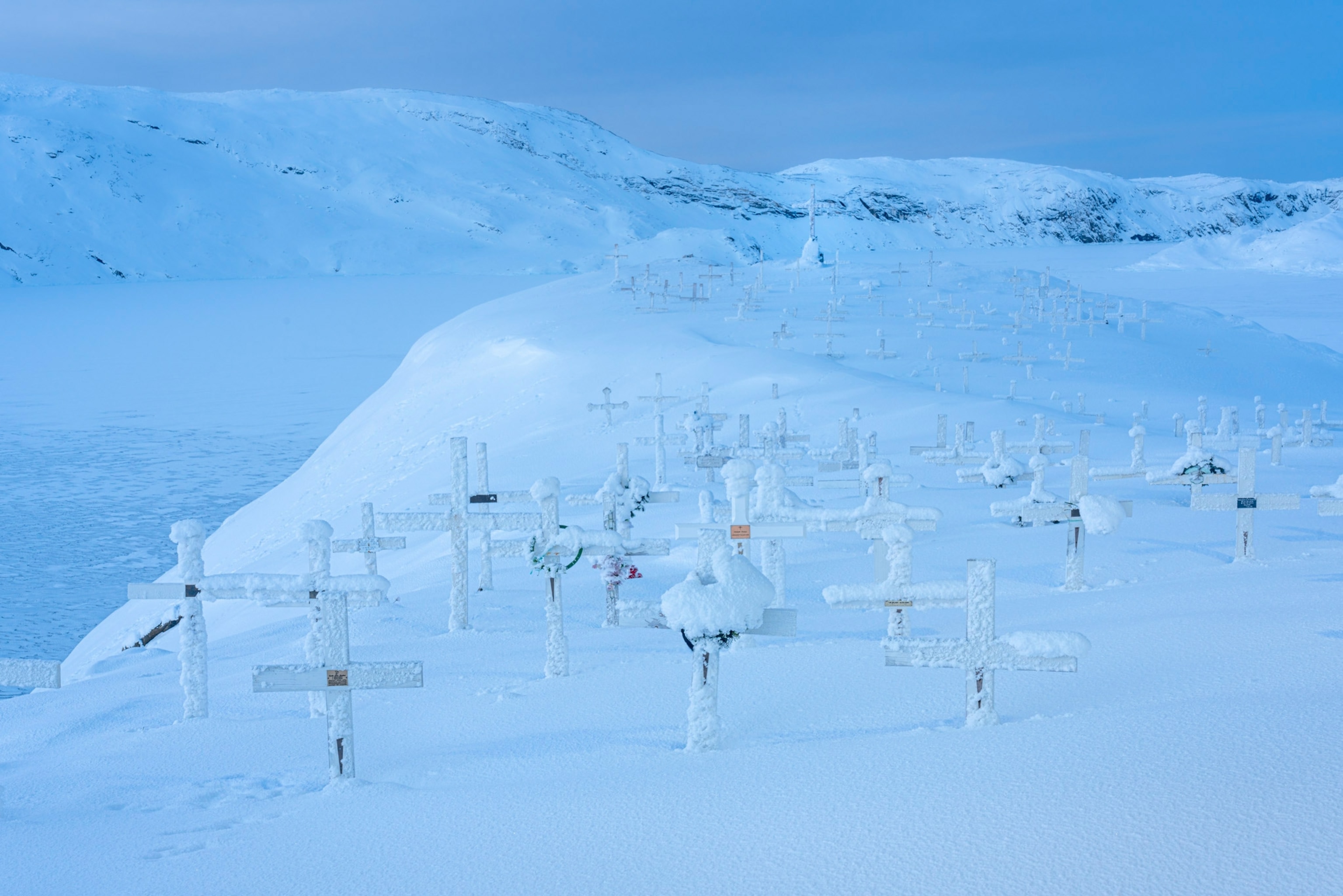 cemetery stones covered in snow in Upernavik, Greenland