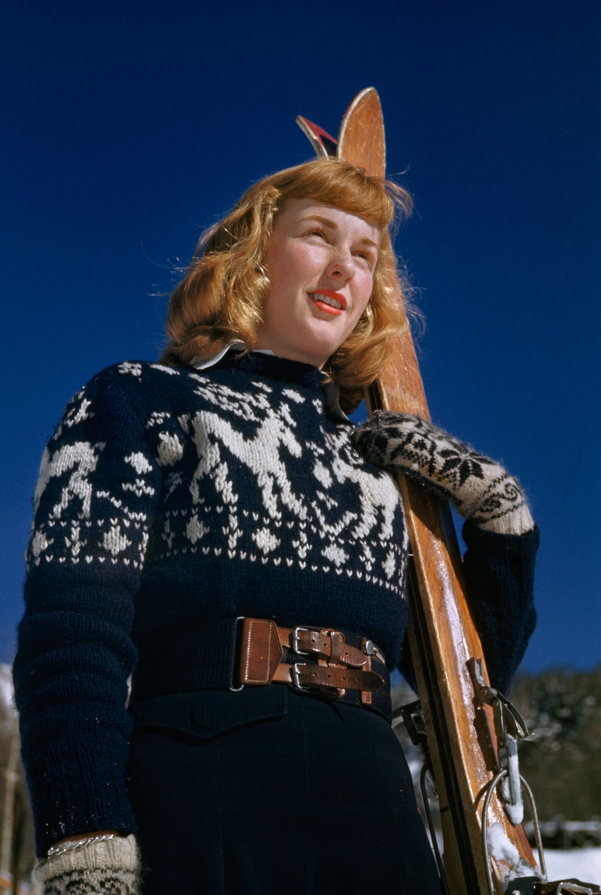 woman in canada with skis and ski sweater