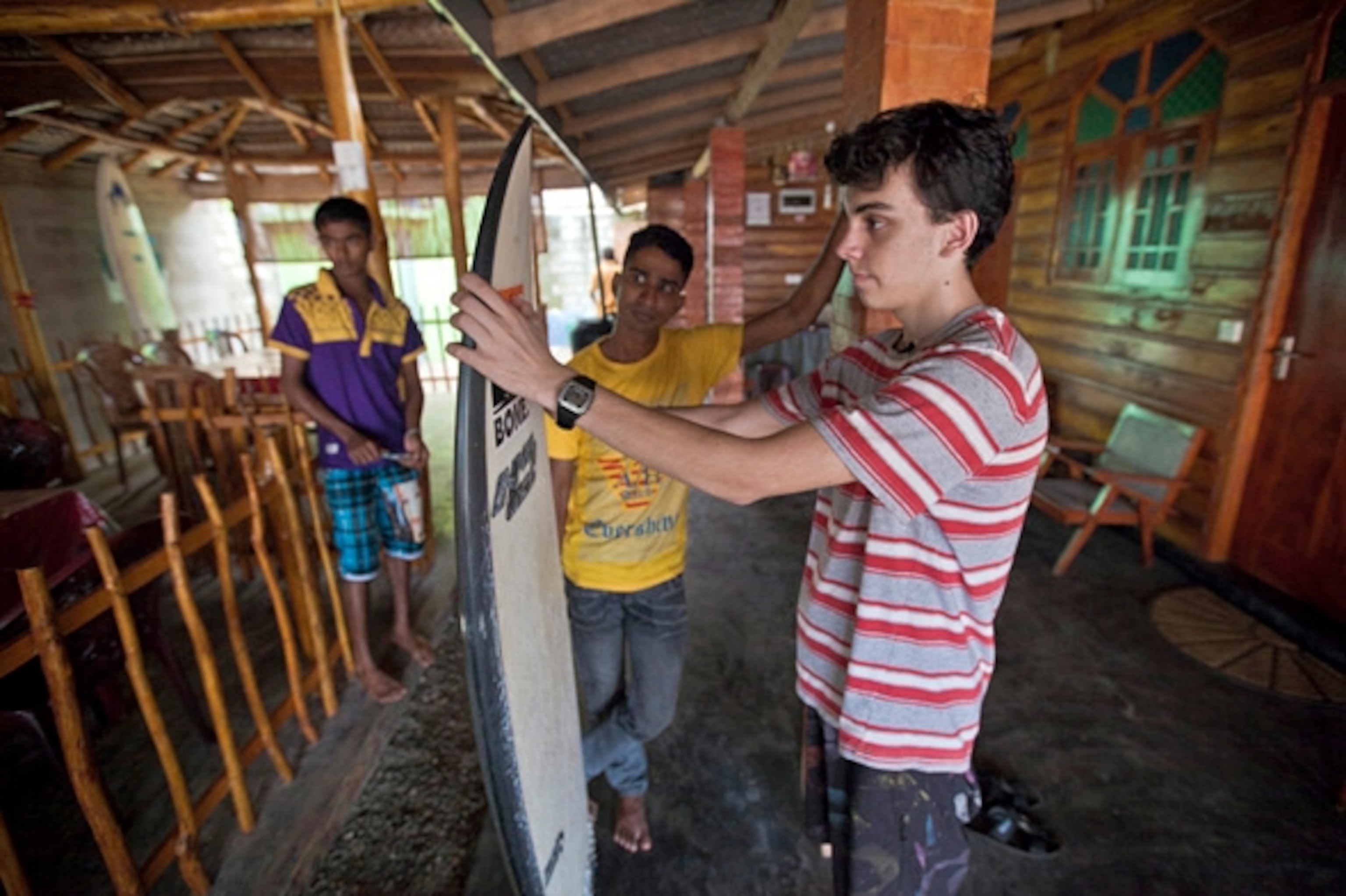 Booker waxing up his surfboard in Sri Lanka. (Photograph courtesy Booker Travels)
