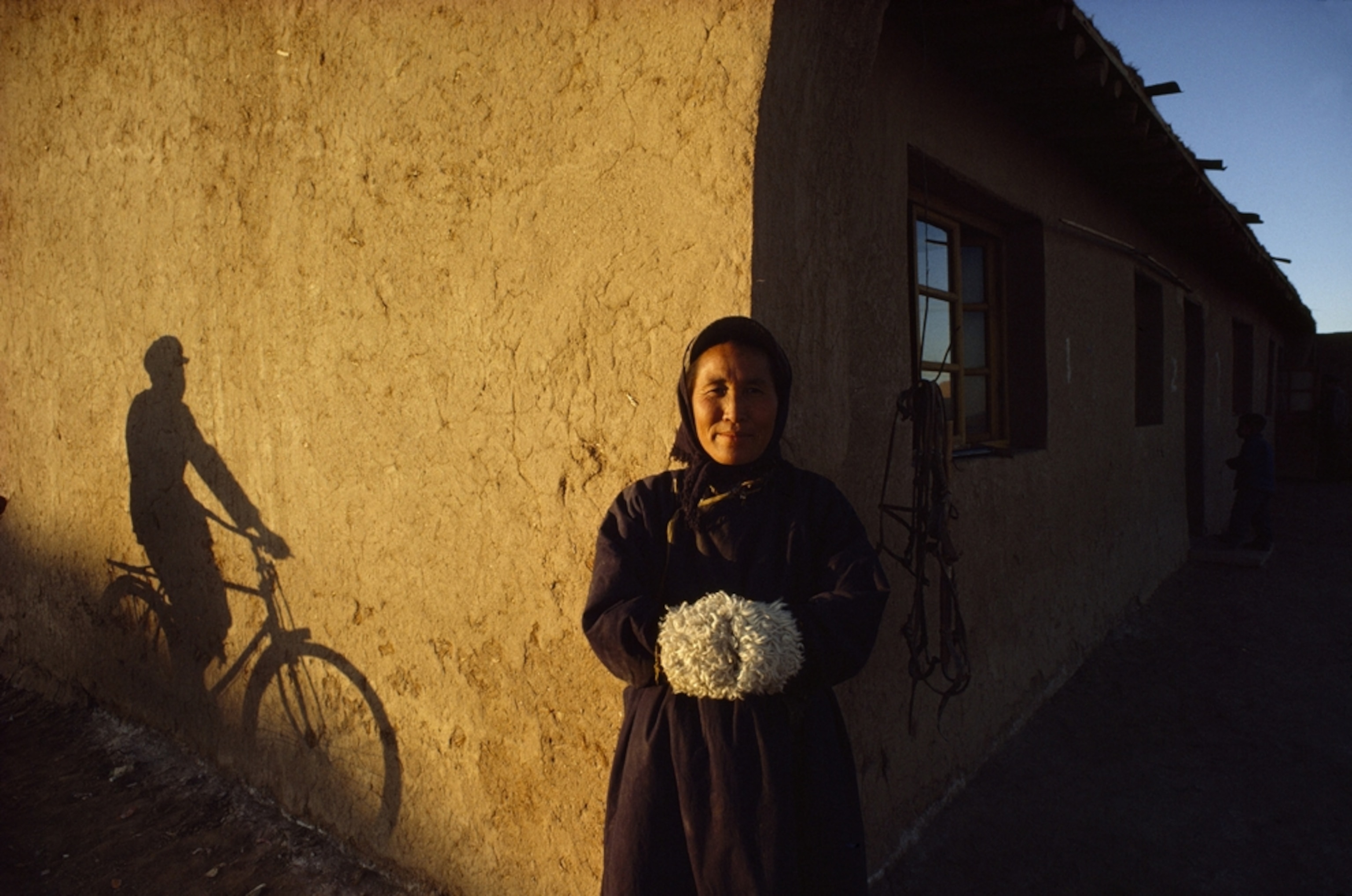 a woman standing near a commune, China