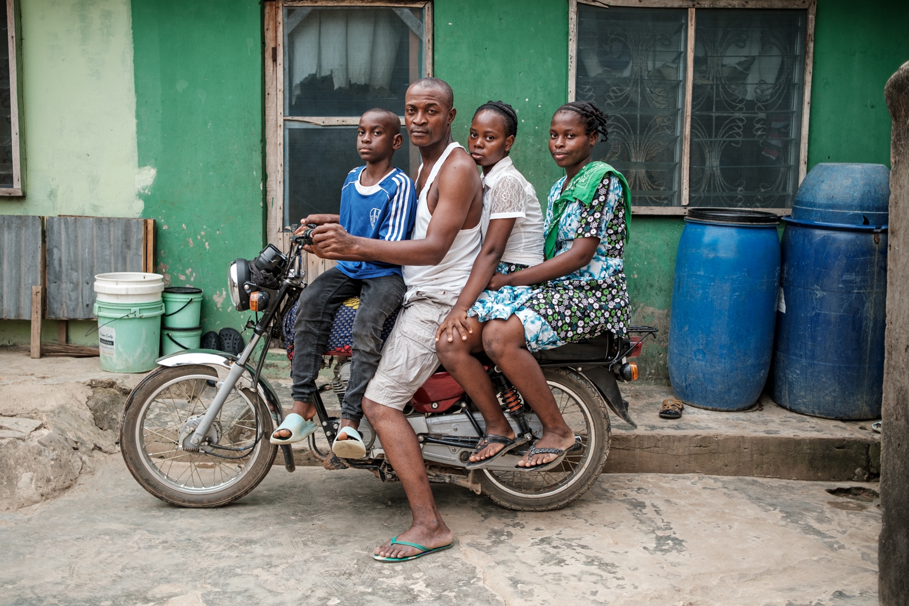 Man on bike with two boys and one girl.
