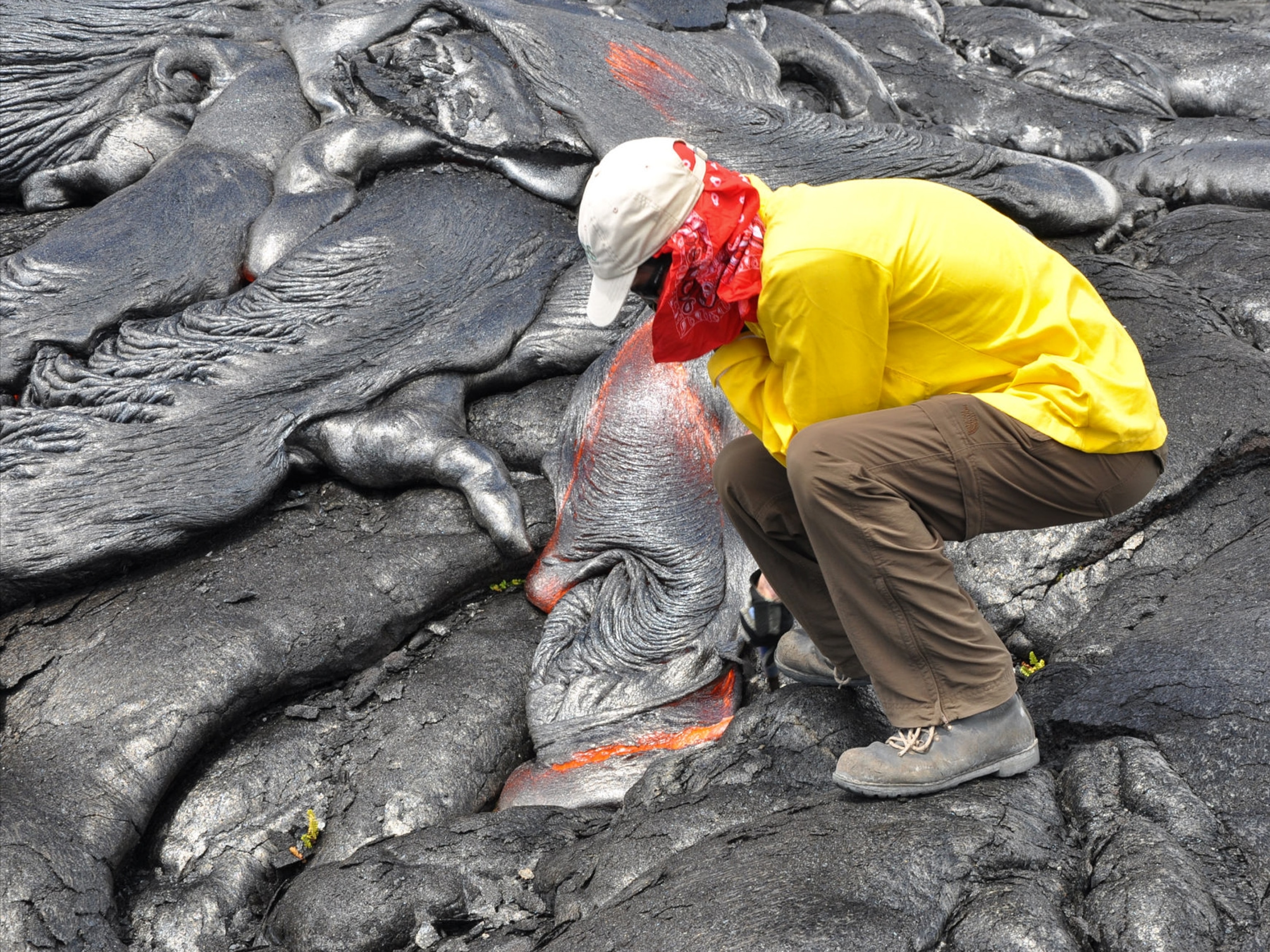 Author Bill Streever examines fresh lava in Hawaii.