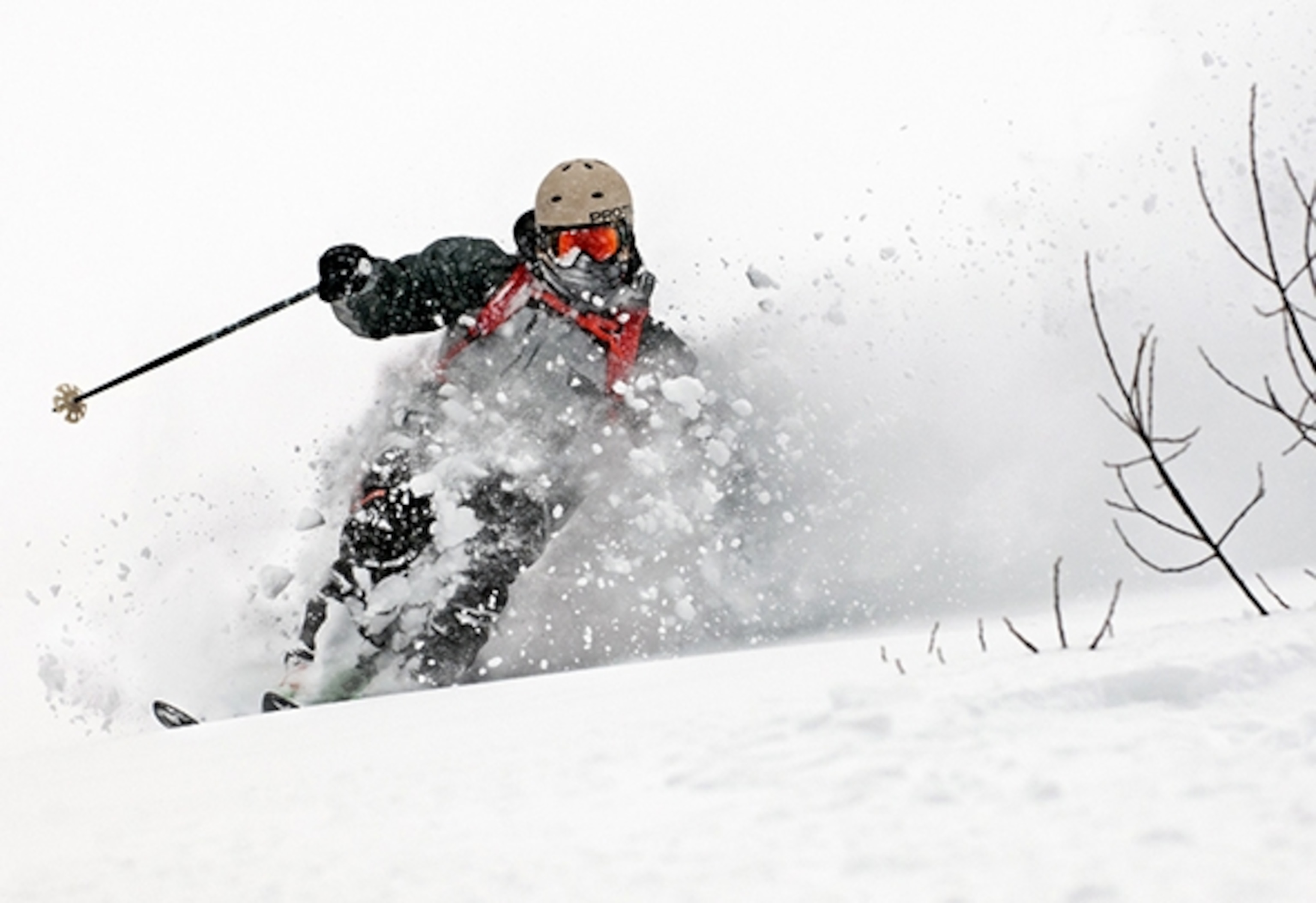 Skier comes out of a turn midst deep powder in backcountry near Fernie, British Columbia. (Photograph by Max Lowe)