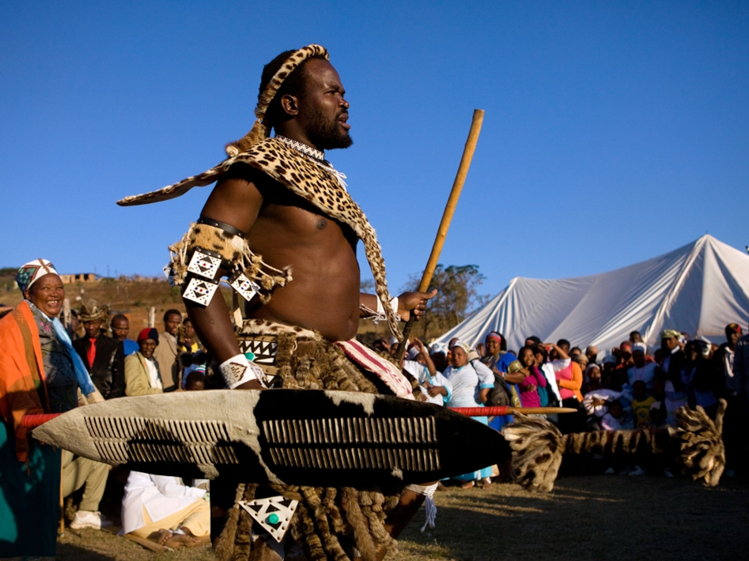 A man dancing in traditional Zulu attire