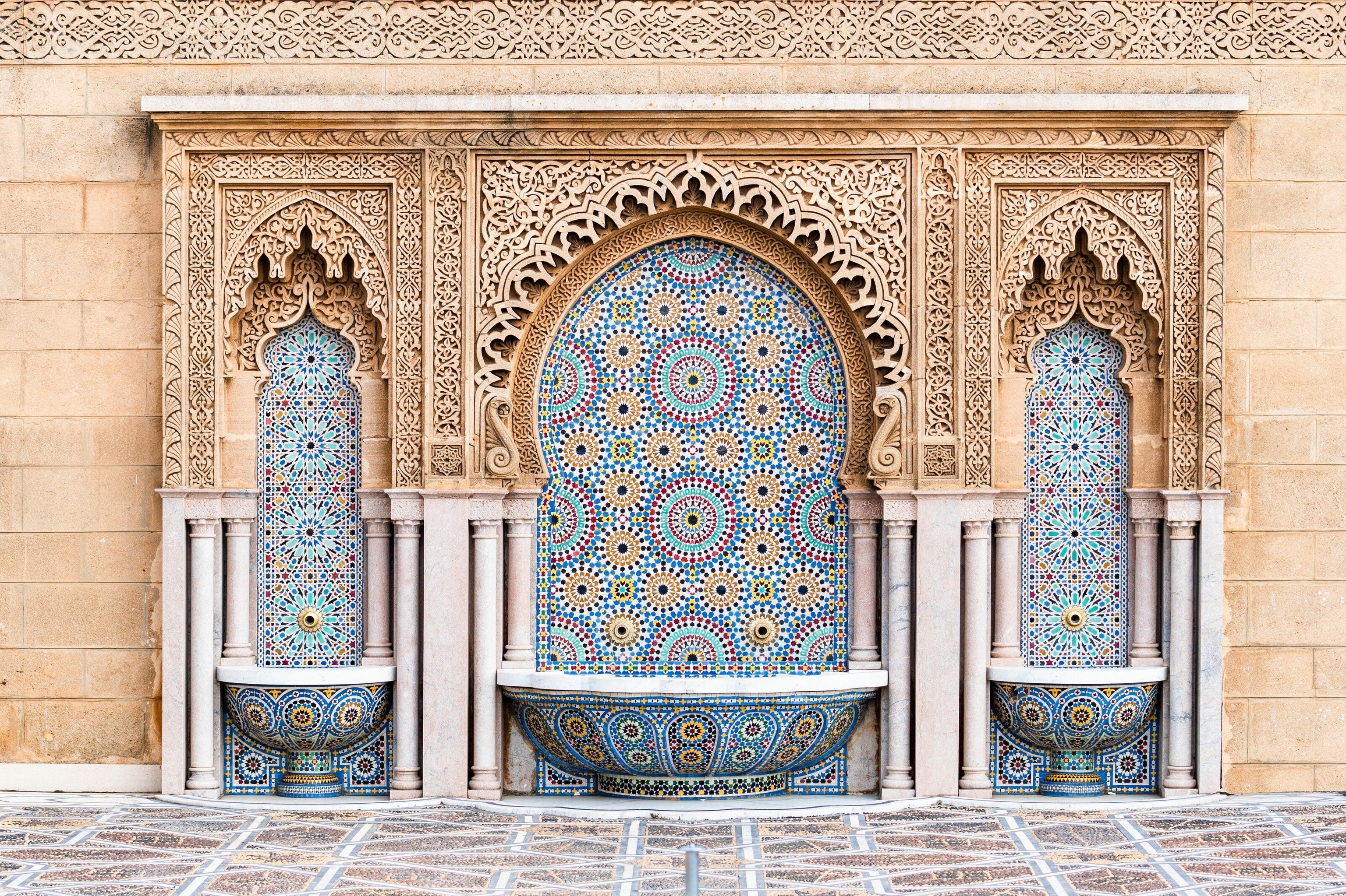 Water fountain with zelige intricate pattern of tiles in classic islamic style on the outside of Mosque Hassan in Rabat, Morocco.