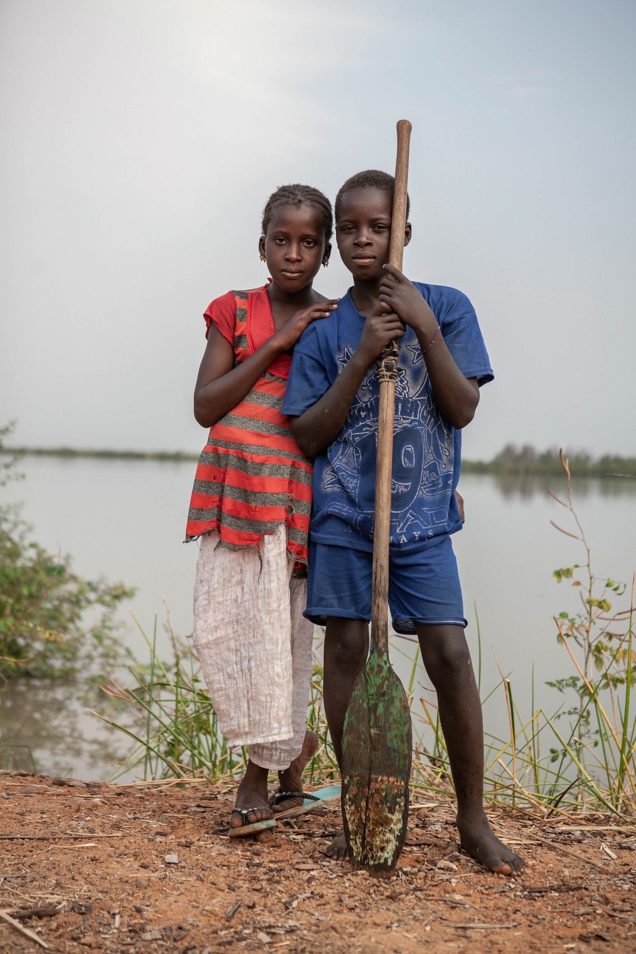 The children of fishermen from the Toucouleur ethnic group. The Toucouleurs migrate seasonally from Senegal to River Gambia to fish for catfish, and live in makeshift camps with their families.