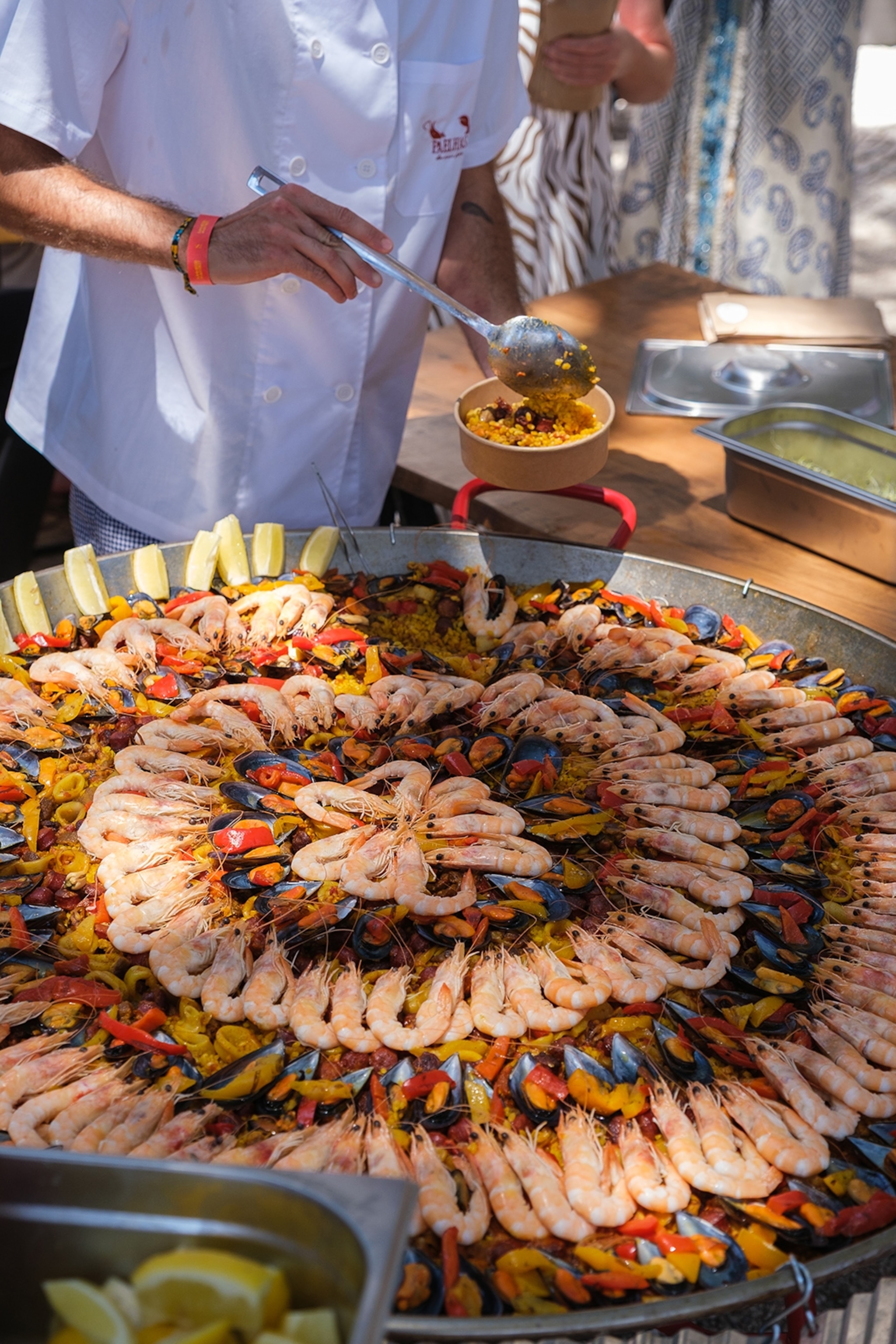 An oversized street food pan filled with a seafood paella.