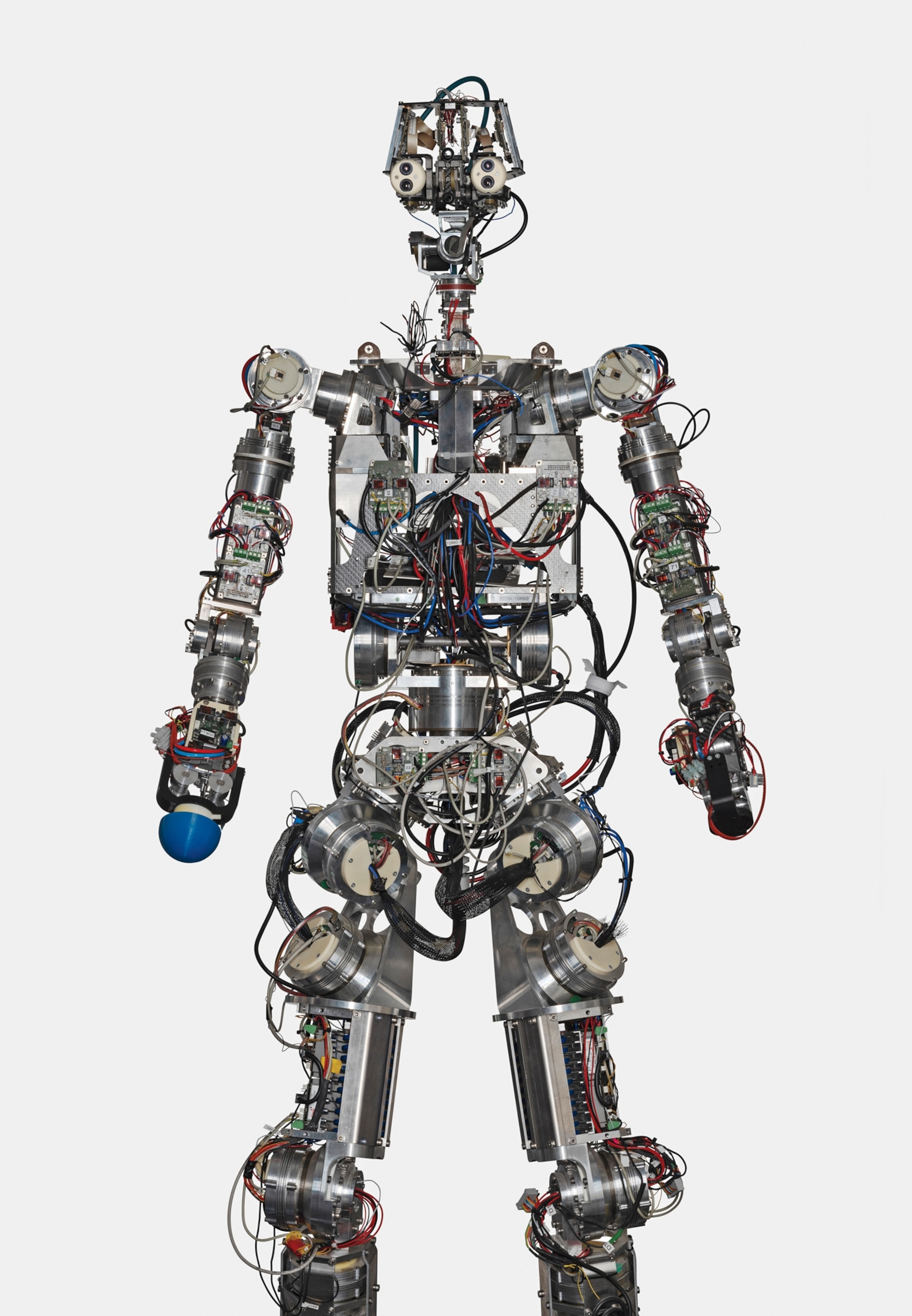 A humanoid robot with exposed circuitry and mechanical joints is shown in a standing position