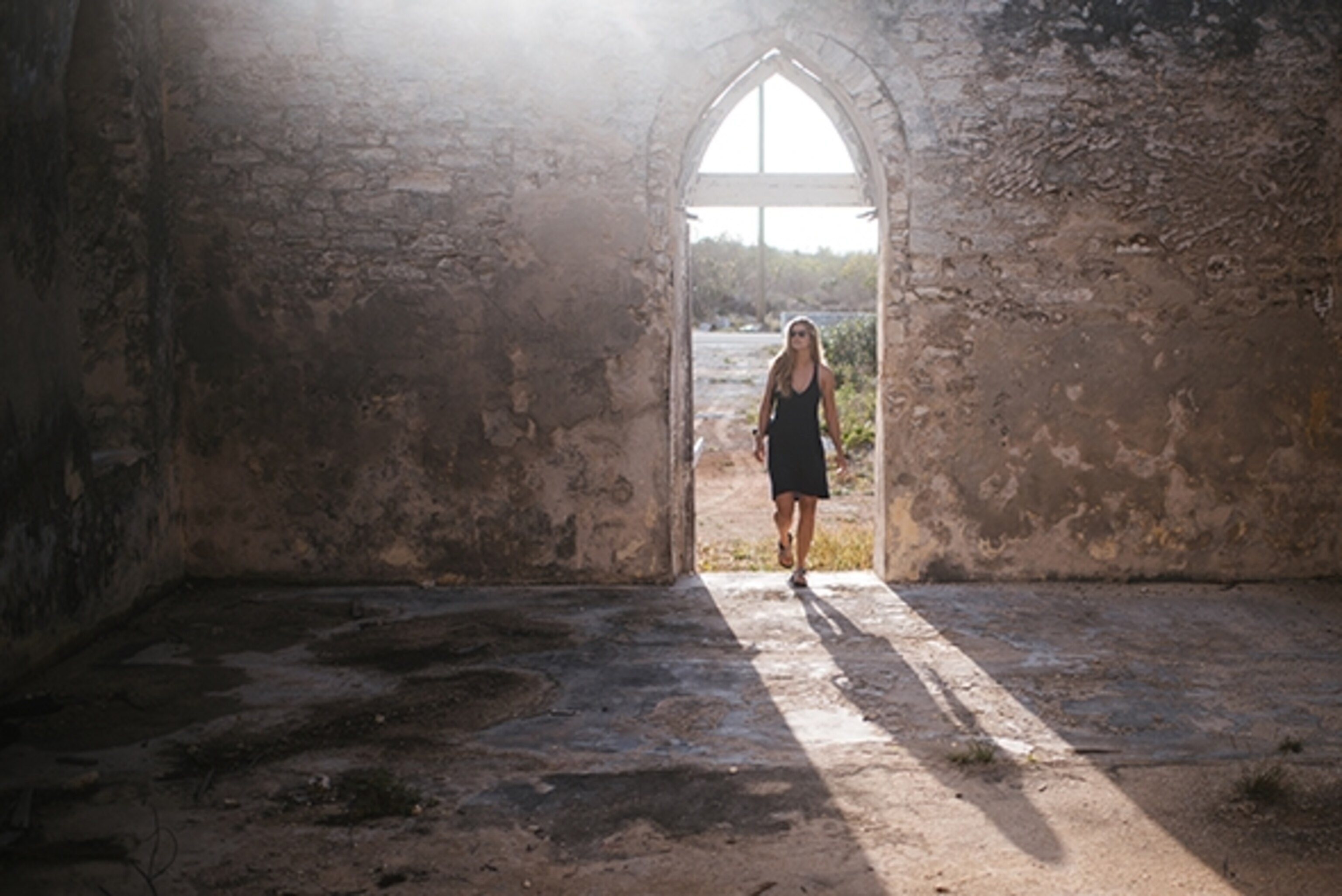 Adventure filmmaker Tahria Sheather walks into the oldest building on Long Island, dating back to the first Spanish settlers that landed on the island in the 1700s; Photograph by Max Lowe