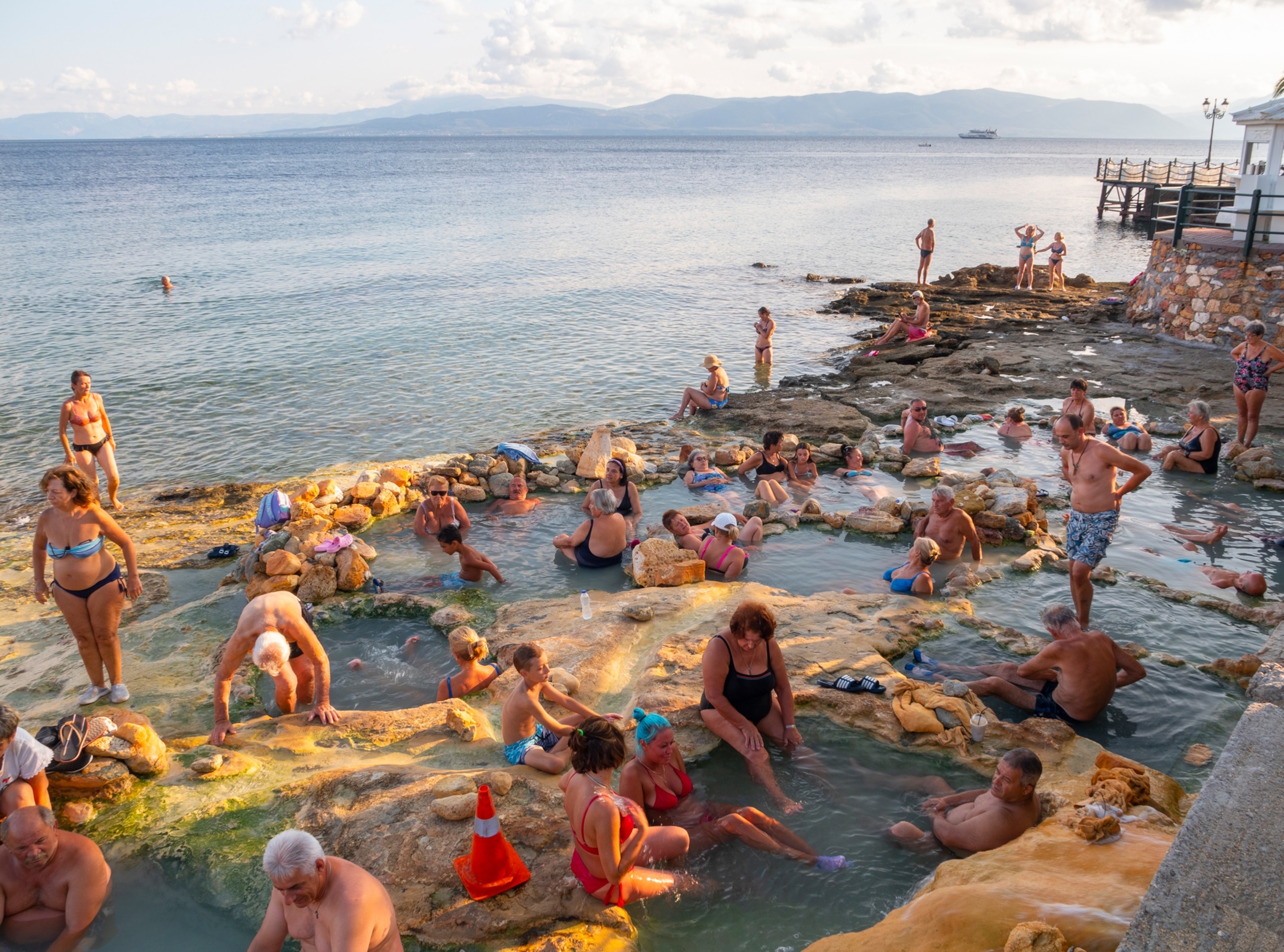 Loutra Edipsou, island Evia, Greece. September 2022: holiday makers take natural healing baths at hot springs with mineral water at a Greek spa resort