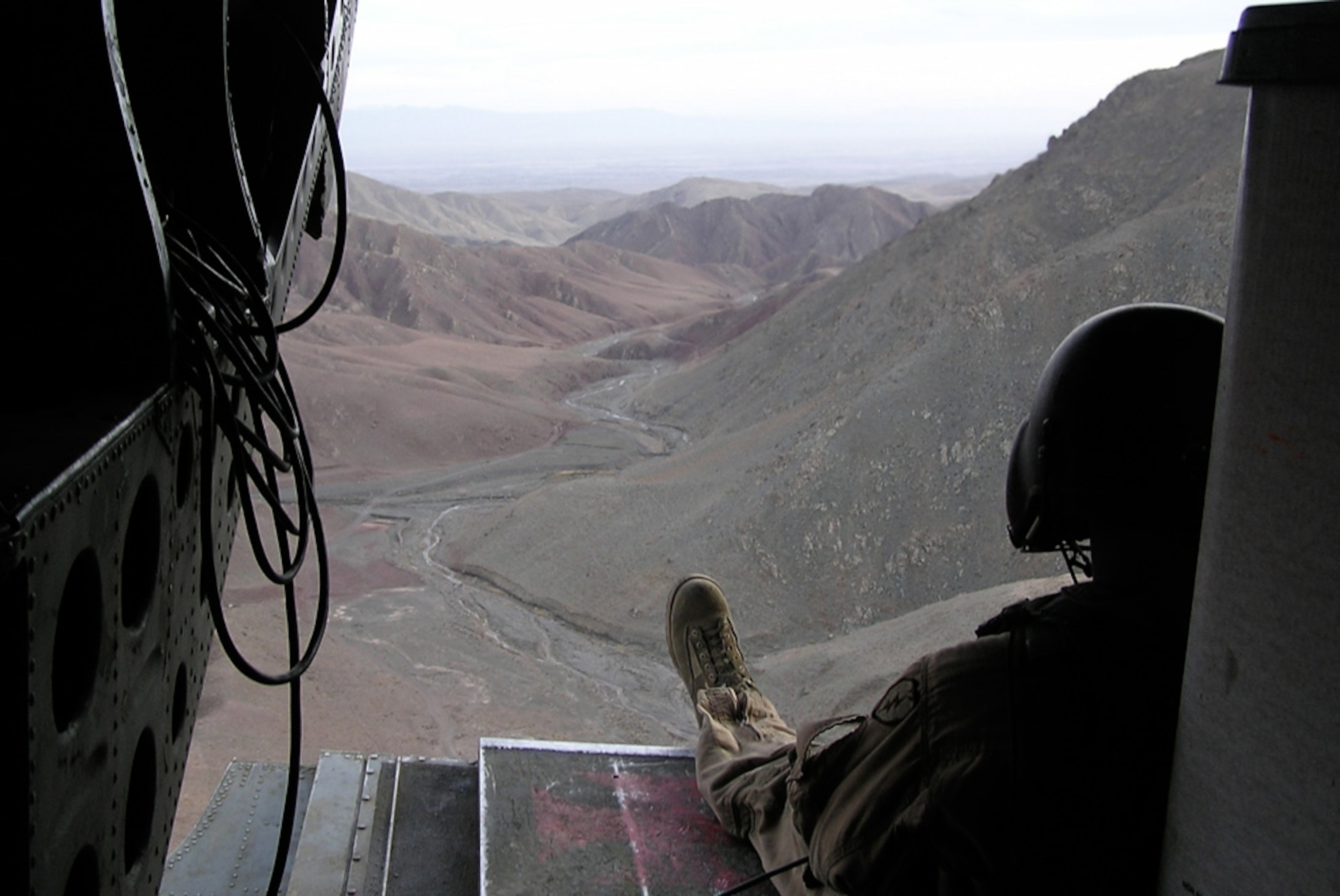 A soldier in a helicopter.