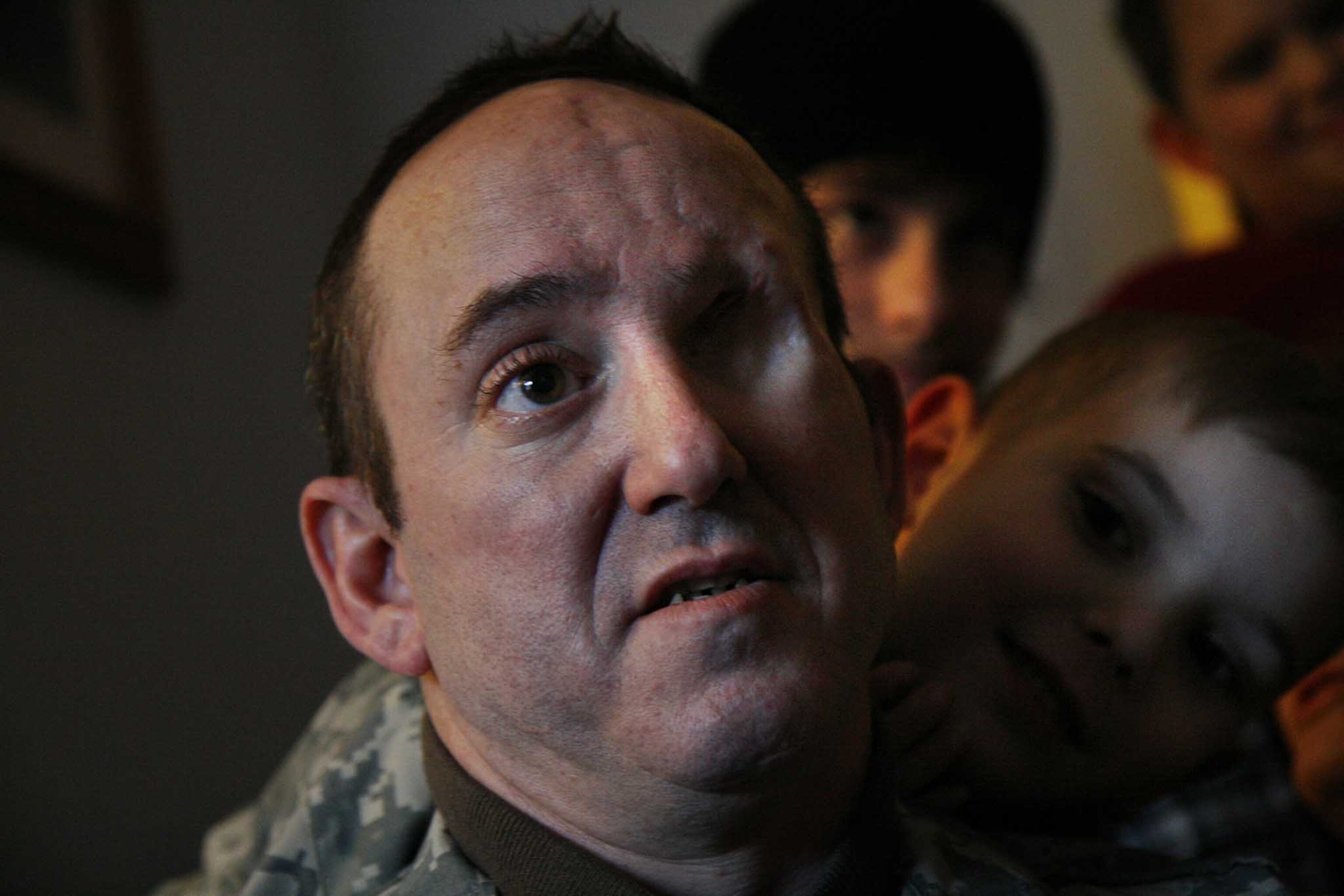 Medical treatment of U.S. military wounded in Iraq. Army SSG. John Daniel Shannon with his son Drake Shannon (at right), 6. "Dan" Shannon was a sniper for Ghost Recon Platoon /2nd Infantry Div. in Iraq when he was injured.