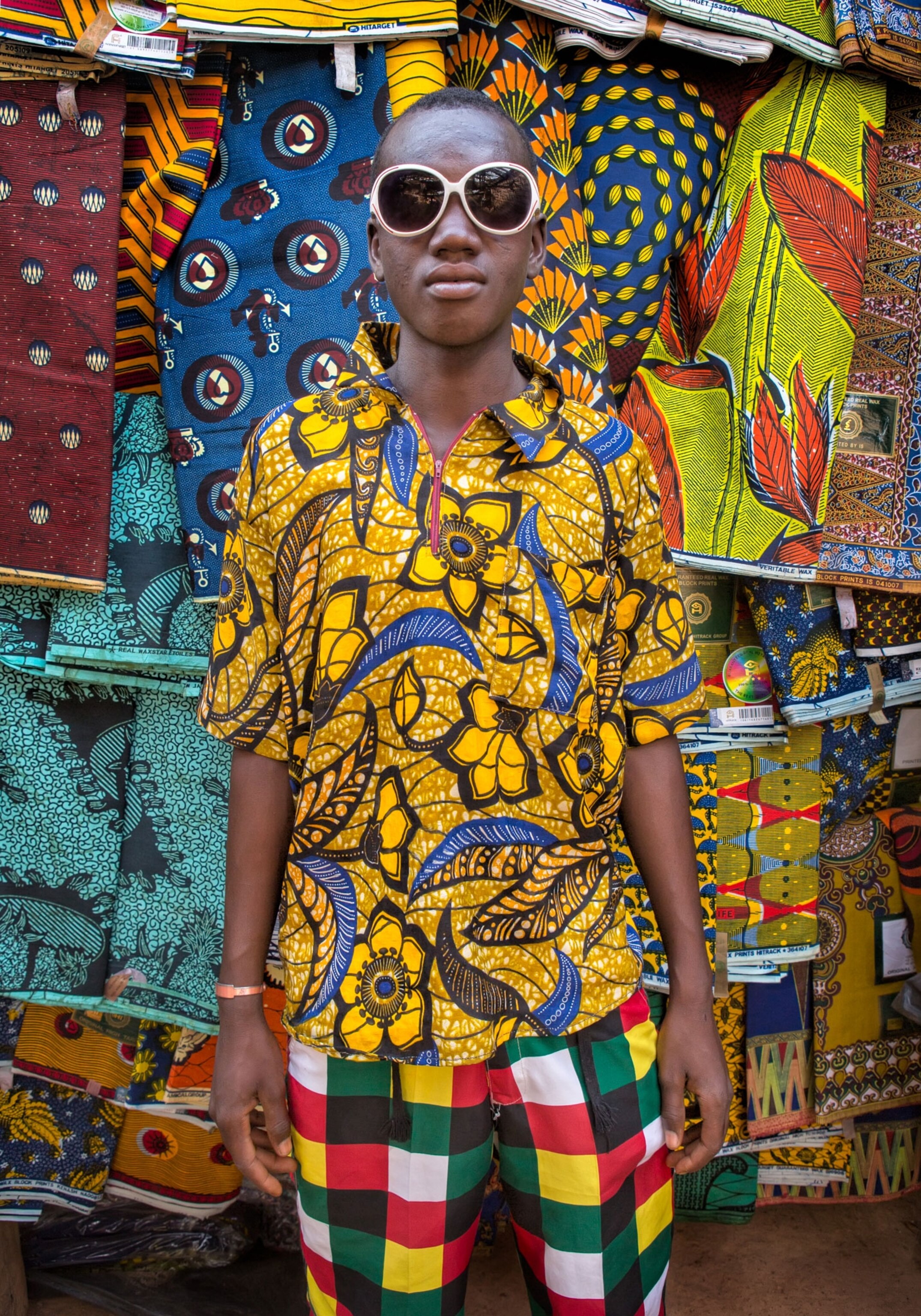 a young man shopping at an outdoor market in Burkina Faso