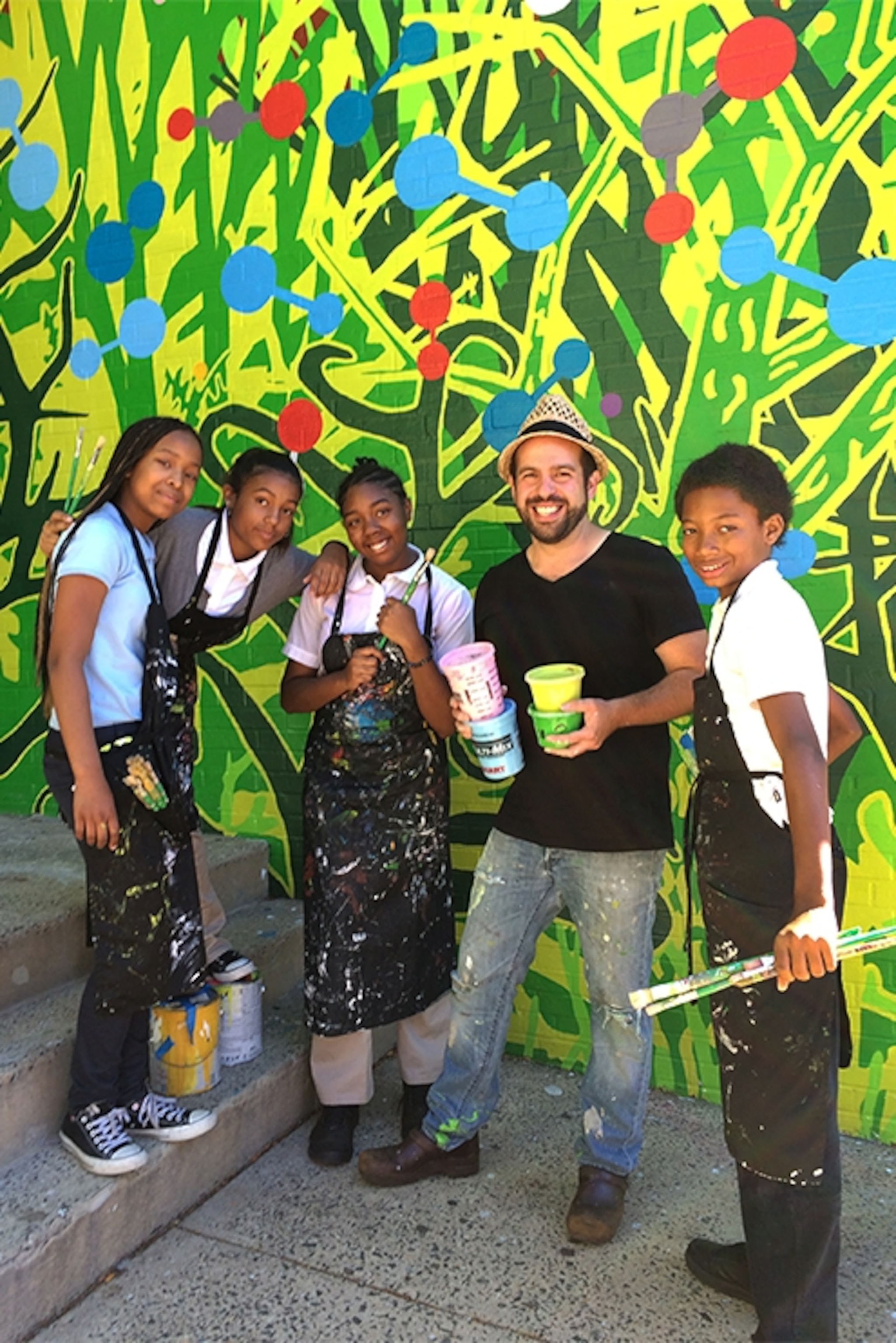 muralist Ben Volta with students in Philadelphia