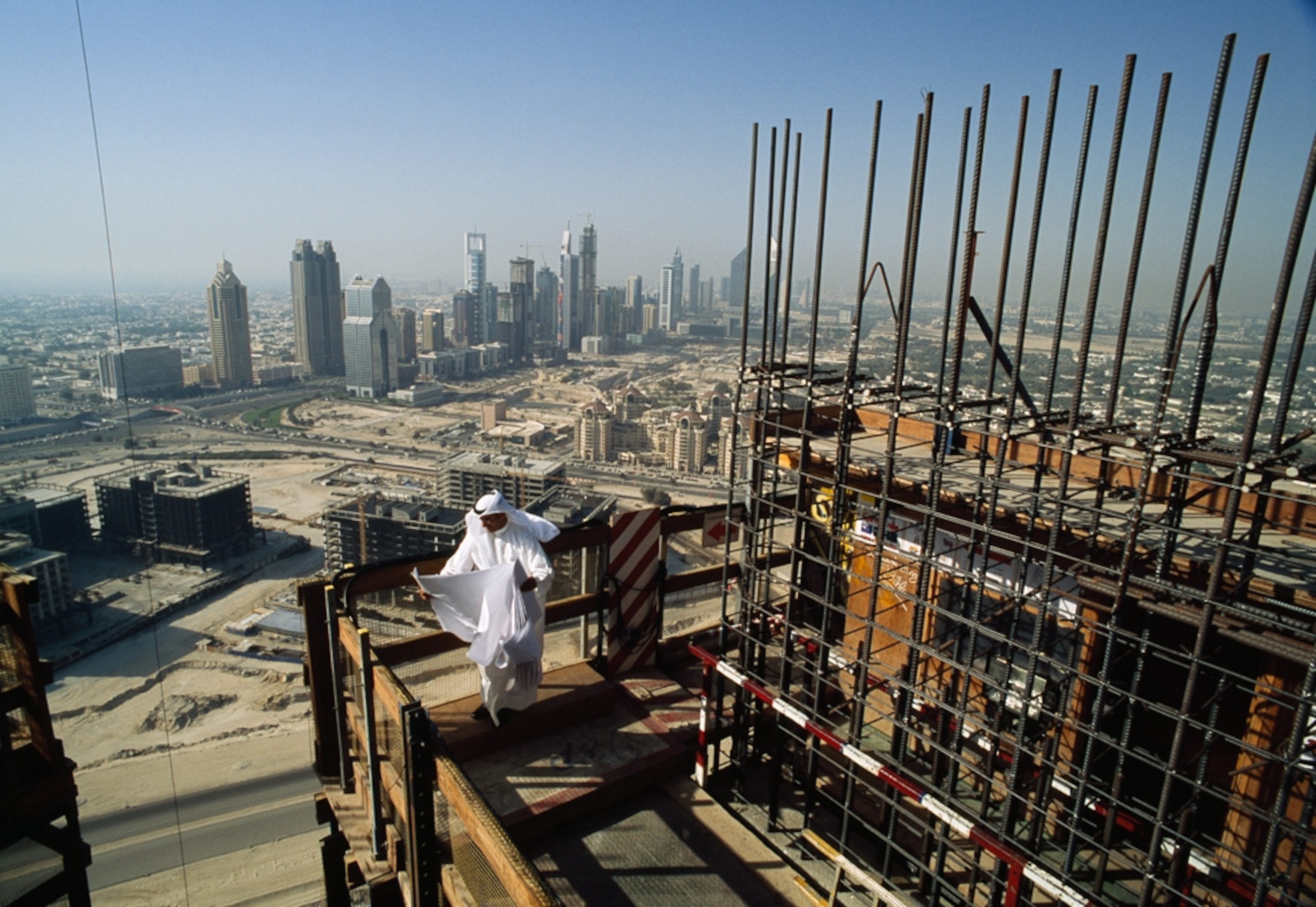 A man walks atop the Burj Khalifa skyscraper under construction in Dubai in 2008.
