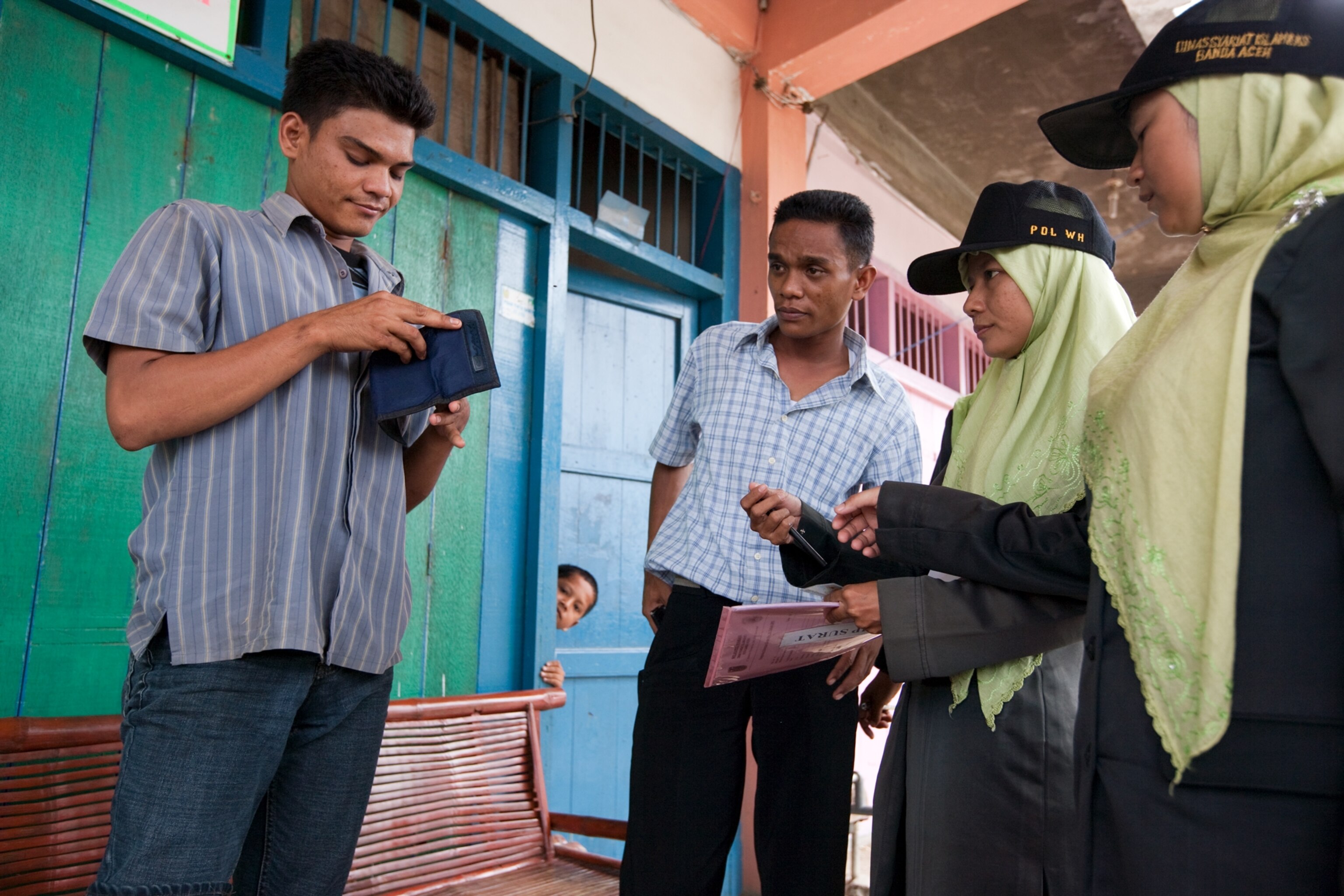 female members of the Banda Aceh Sharia Patrol citing men for missing Friday prayers