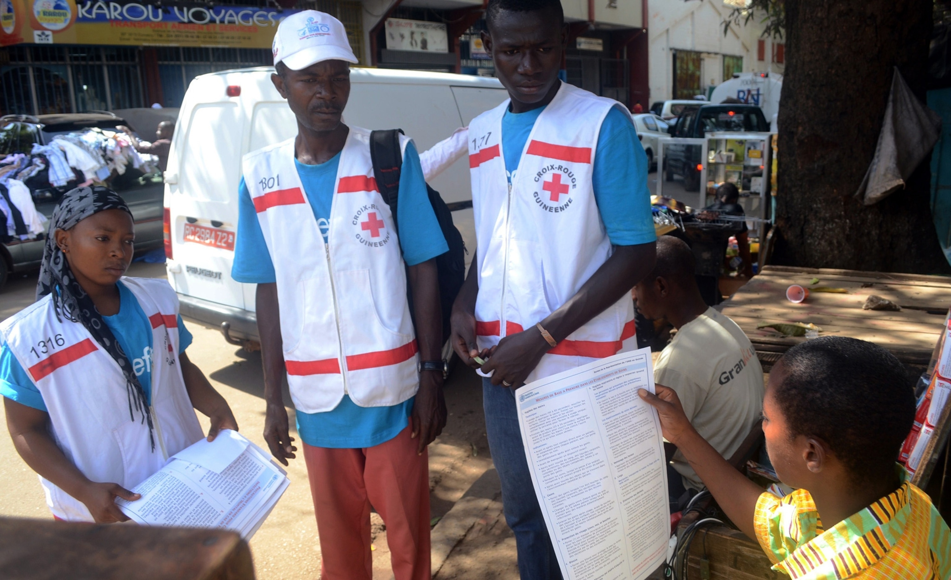 Staff of the 'Doctors without Borders' ('Medecin sans frontieres') medical aid organisation carry the body of a person killed by viral haemorrhagic fever, at a center for victims of the Ebola virus in Guekedou, on April 1, 2014. The viral haemorrhagic fever epidemic raging in Guinea is caused by several viruses which have similar symptoms -- the deadliest and most feared of which is Ebola. AFP PHOTO / SEYLLOU (Photo credit should read SEYLLOU/AFP/Getty Images)