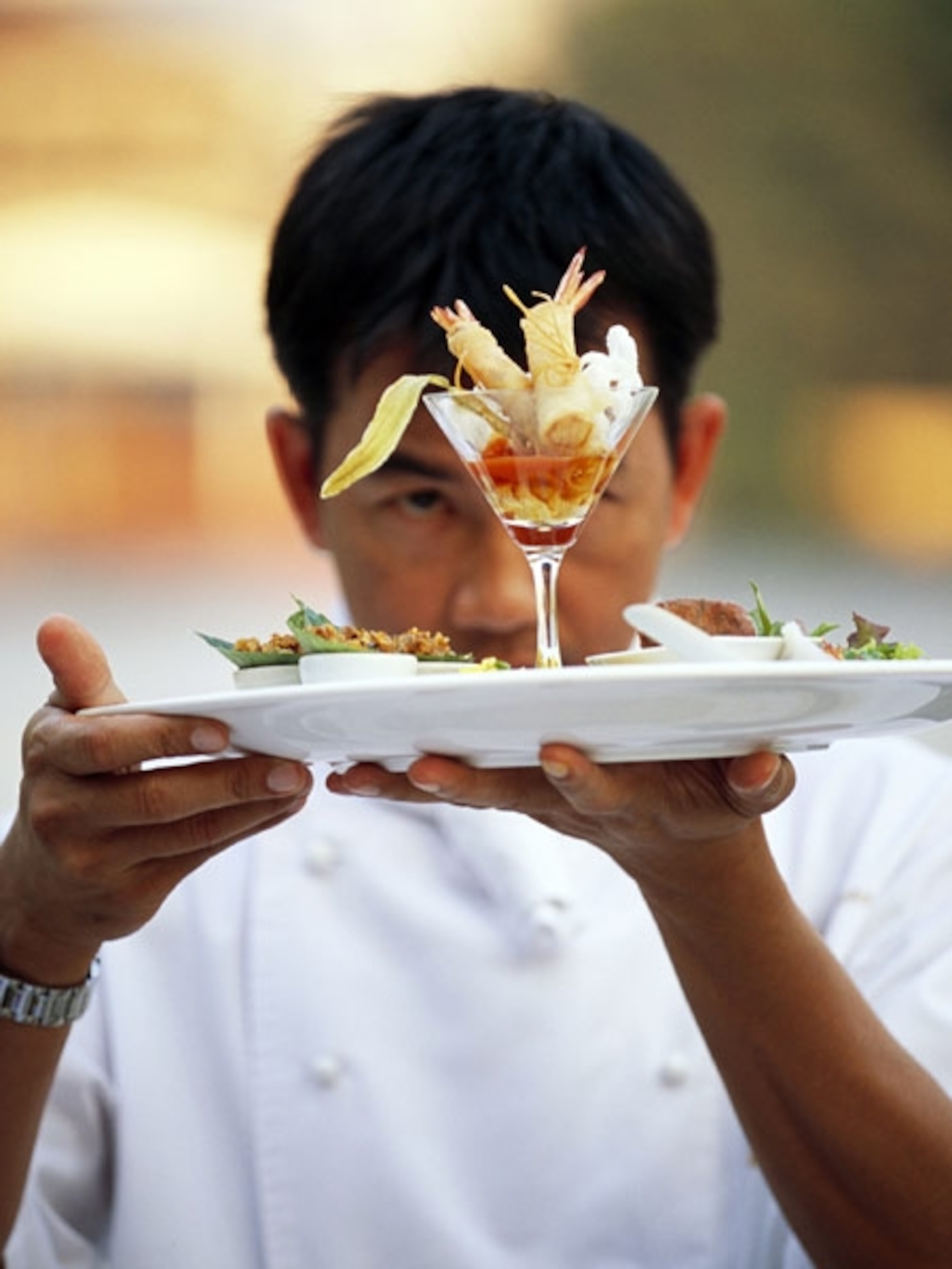 Waiter carrying plate of food
