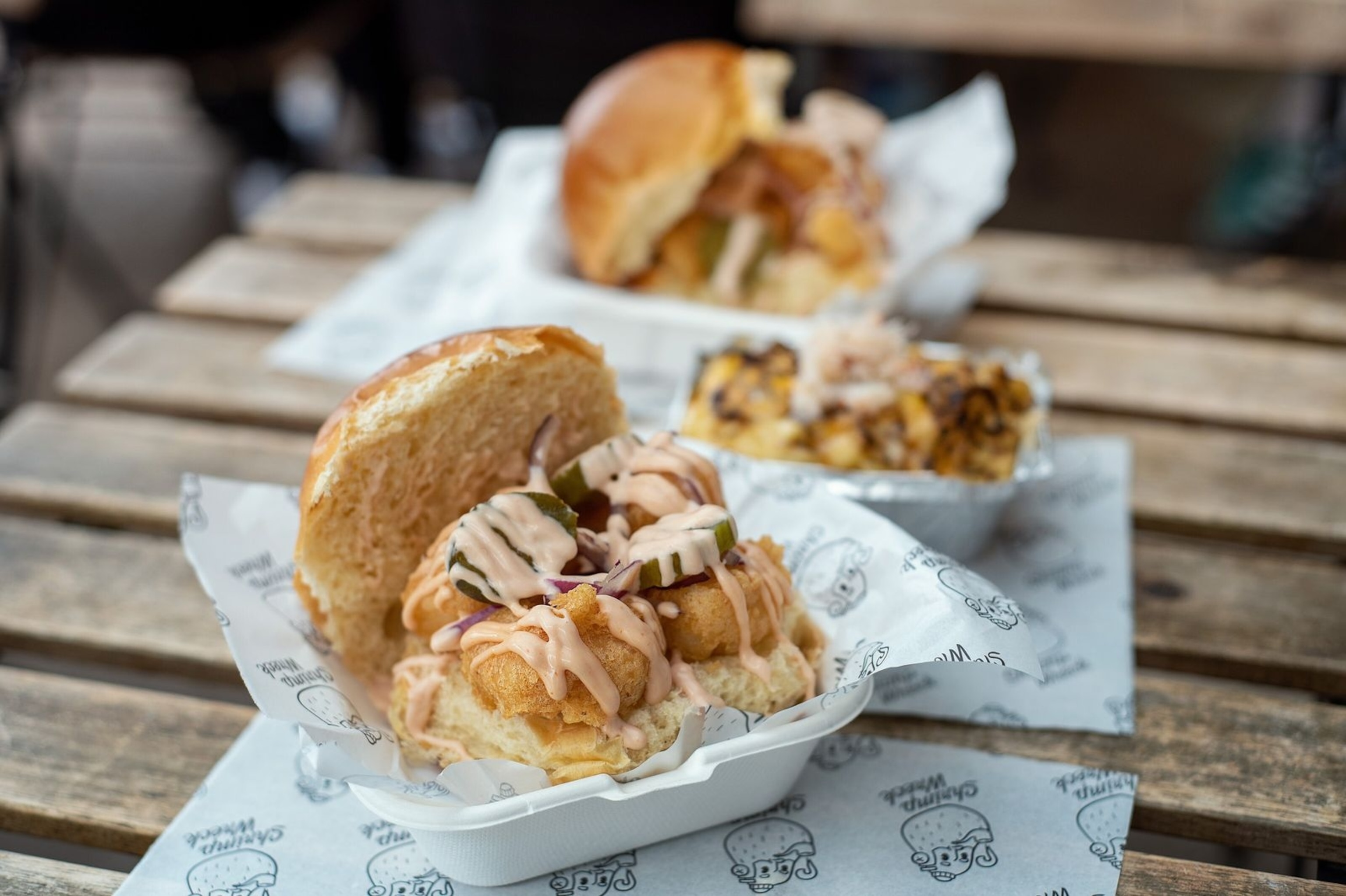 Shrimp bun at ShrimpWreck — a hearty portion of battered king prawns, bacon, red onion, marie rose sauce and pickles, all packed into a sturdy bread roll.