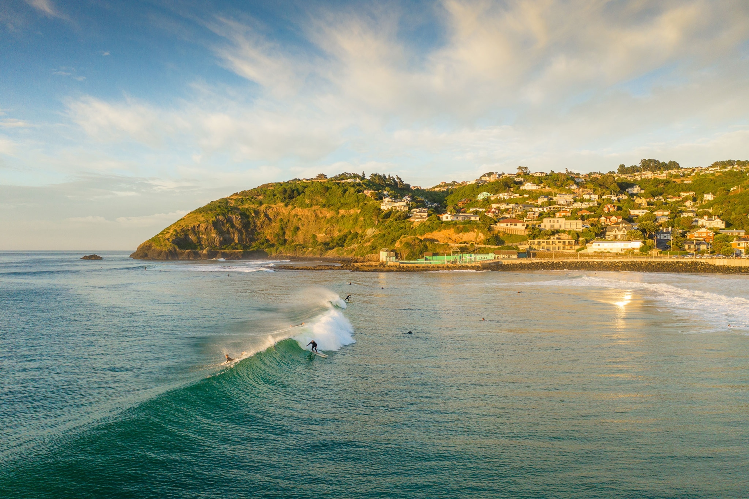 Surfers in the water at St Clair Beach, Dunedin, New Zealand
