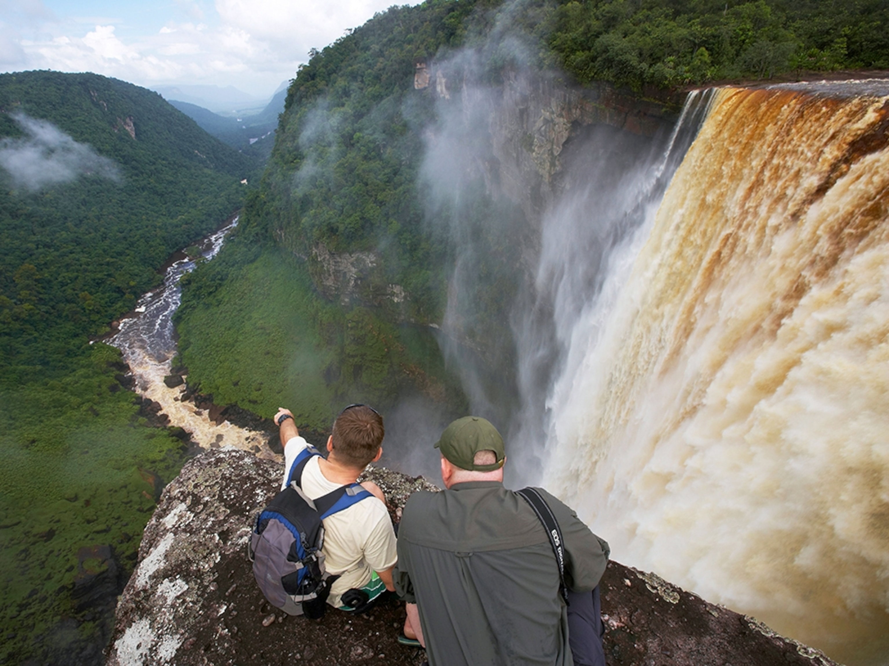 two men looking over Kaieteur Falls, Guyana