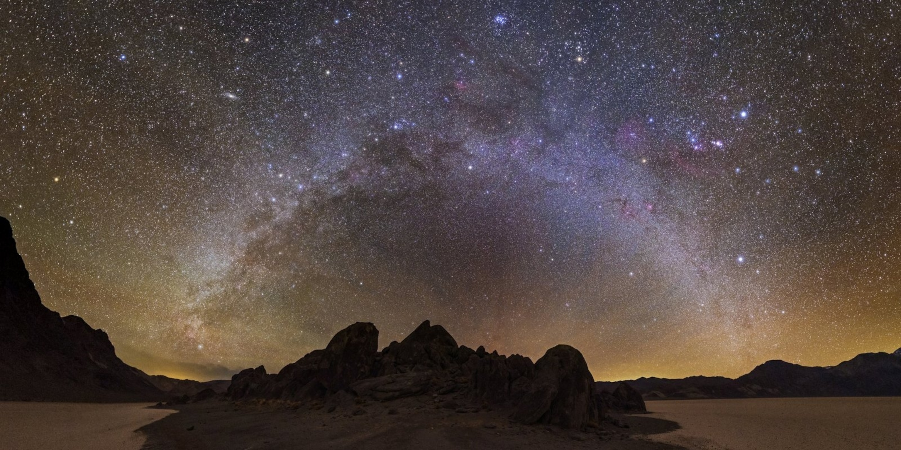 A photo of the night sky at over the desert with views of the Milky Way.