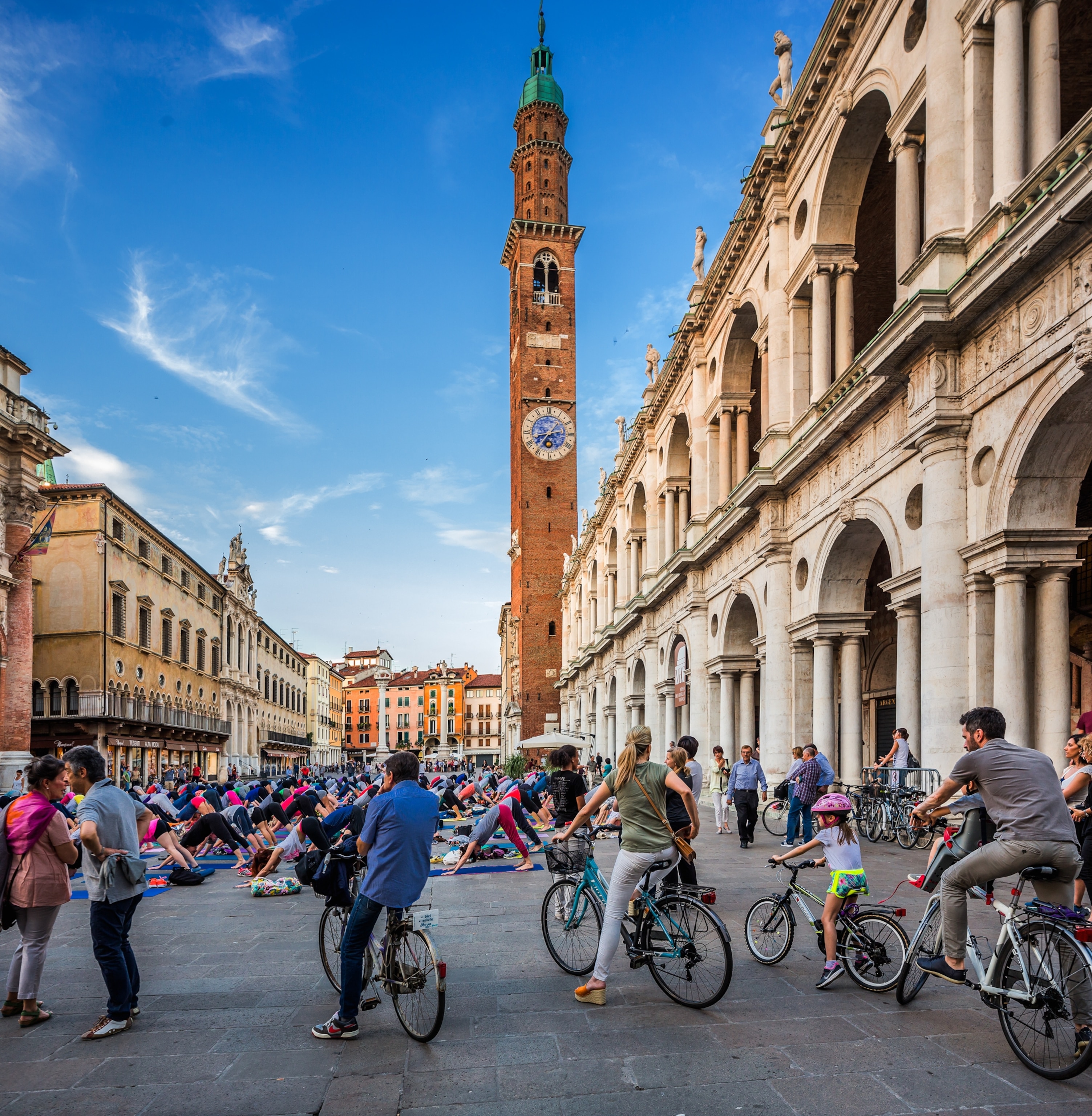 Bicycles in Piazza (square) dei Signori, the Basilica Palladiana (Palladio architect) on the right, the Torre (tower) Bissara on the background (Treviso-Ostiglia Cycle Route, Italy)