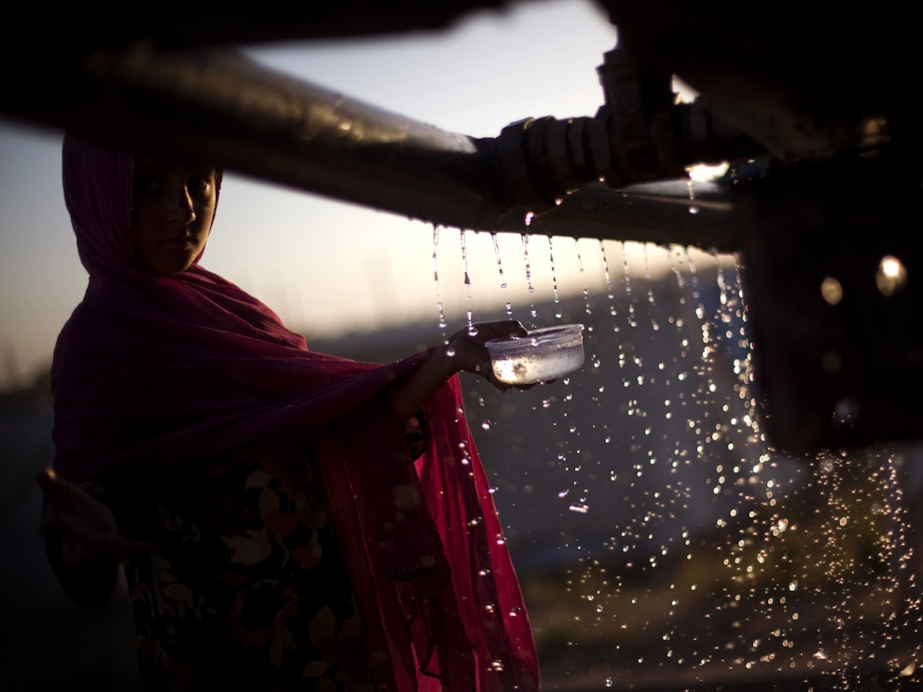 Pakistani girl fills her cup