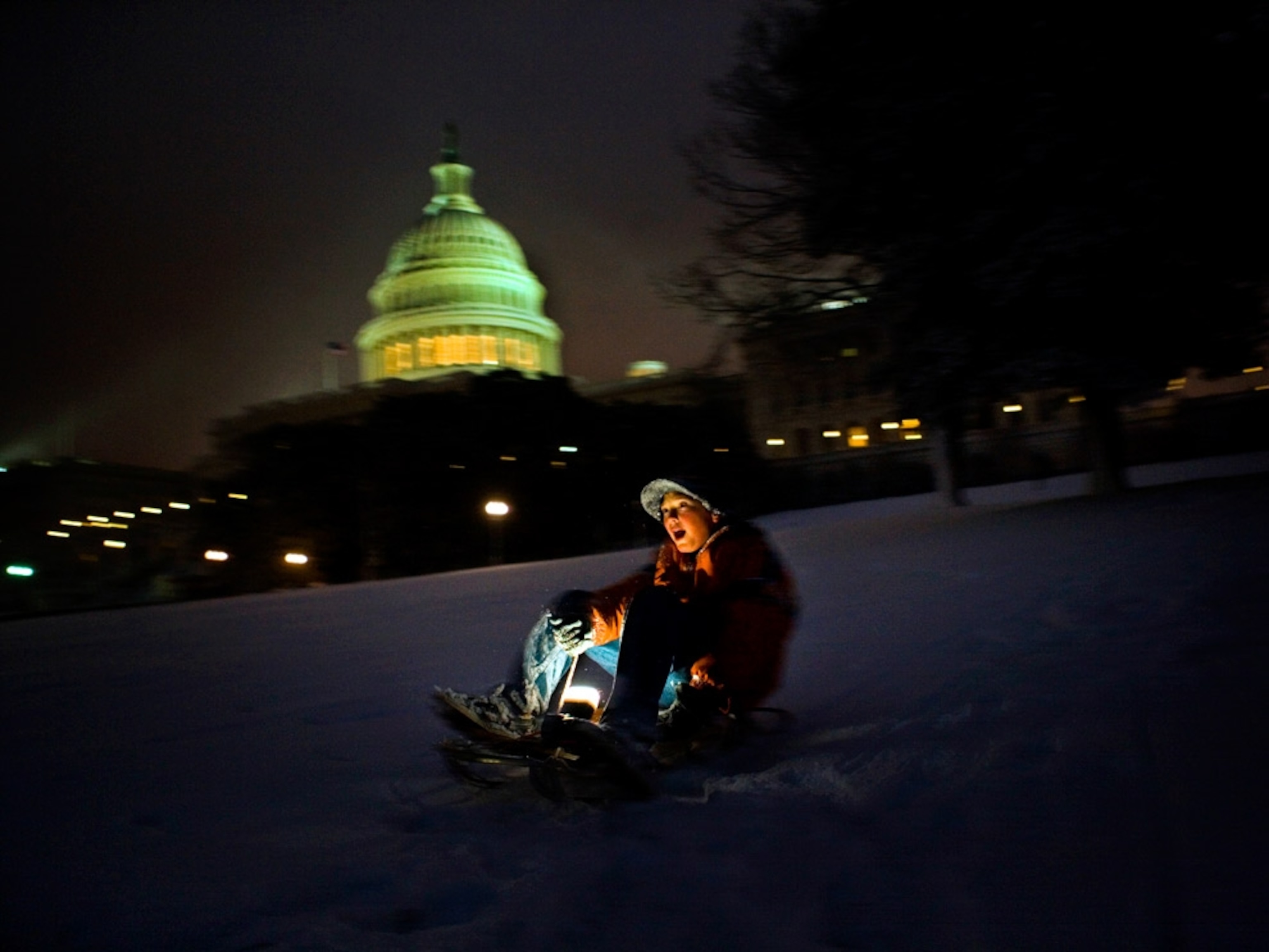 A sledder at night
