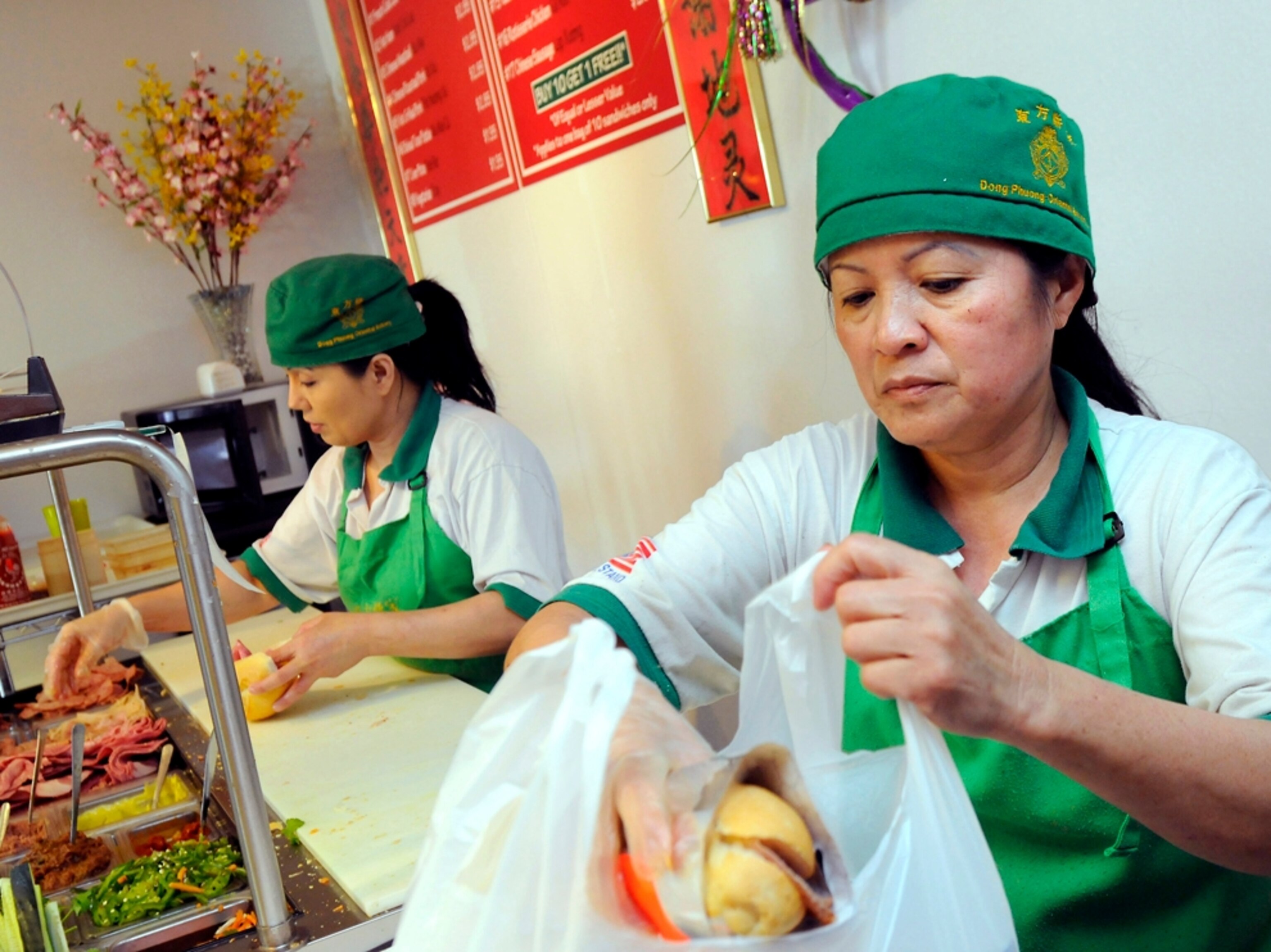 cooks preparing banh mi at Dong Phuong Oriental Restaurant and Bakery, New Orleans