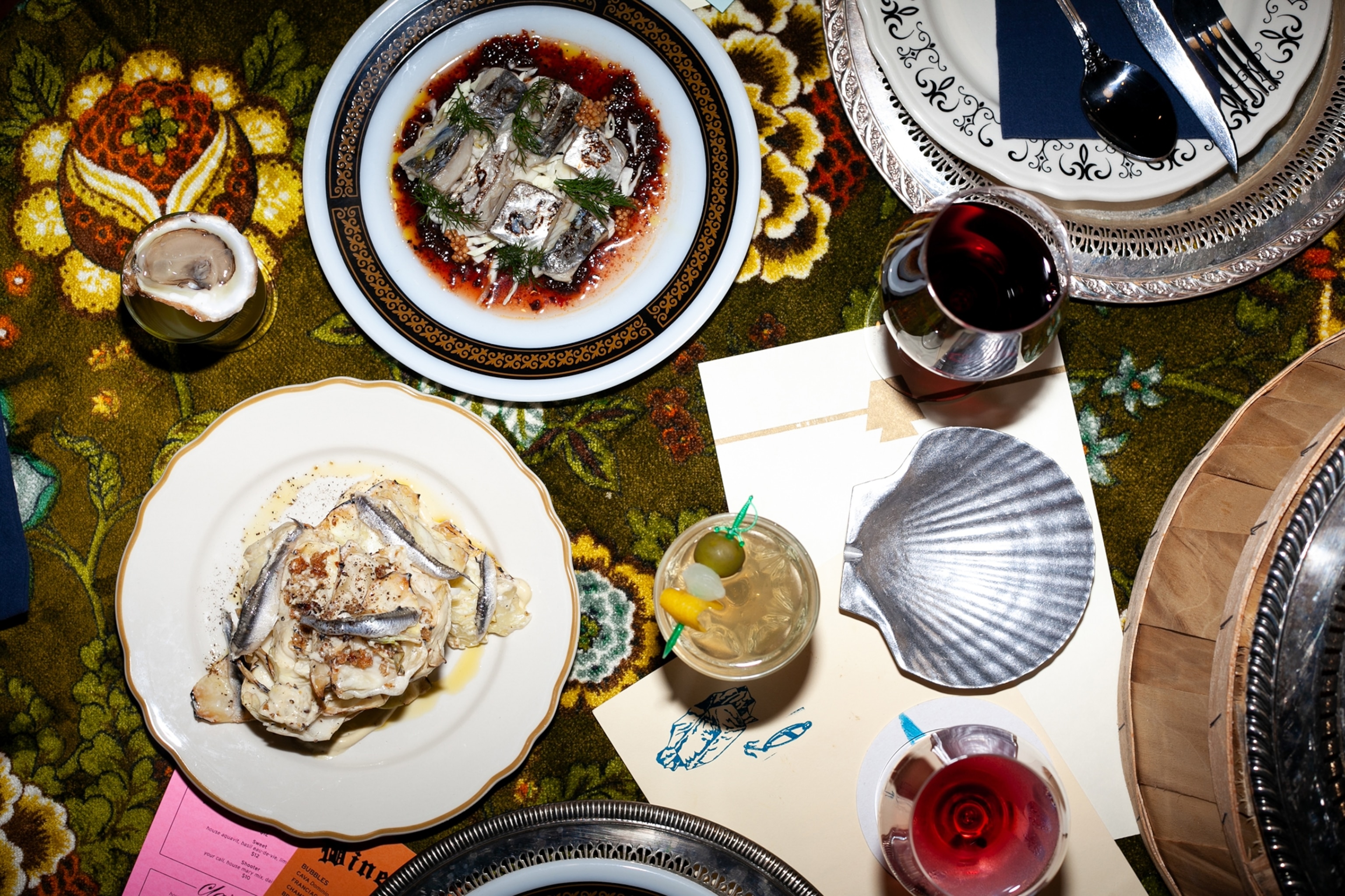An image showing some of FET-FISK's most popular dishes: the pickled mackerel, grilled caesar salad, our filthy martini which uses dulse seaweed+castelvetrano super brine. Photo credit: Sarah LaPonte