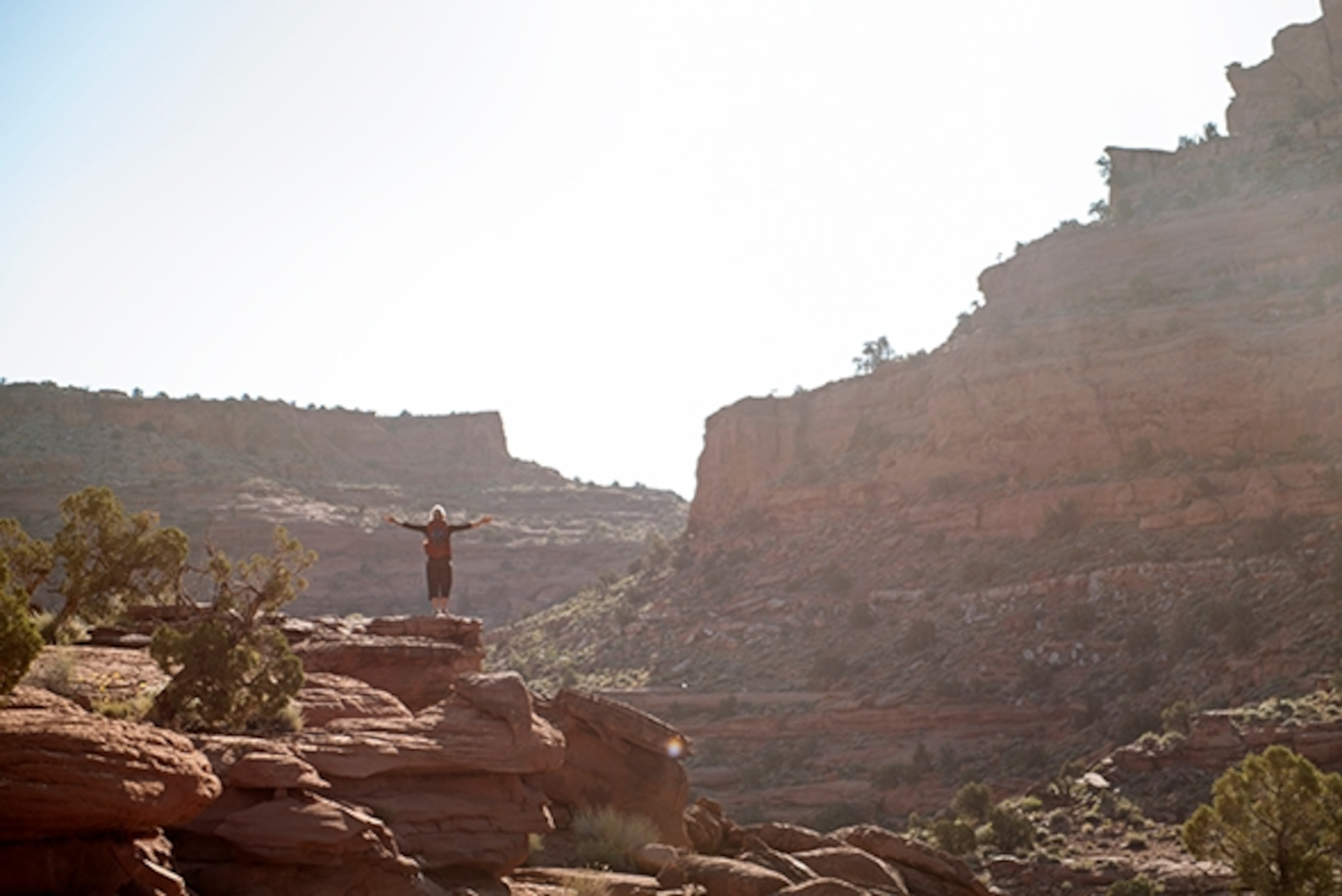 Kalen Thorien soaks in the immensity of the environment around here on the rim of Neon Canyon, Escalante, Utah; Photograph by Max Lowe
