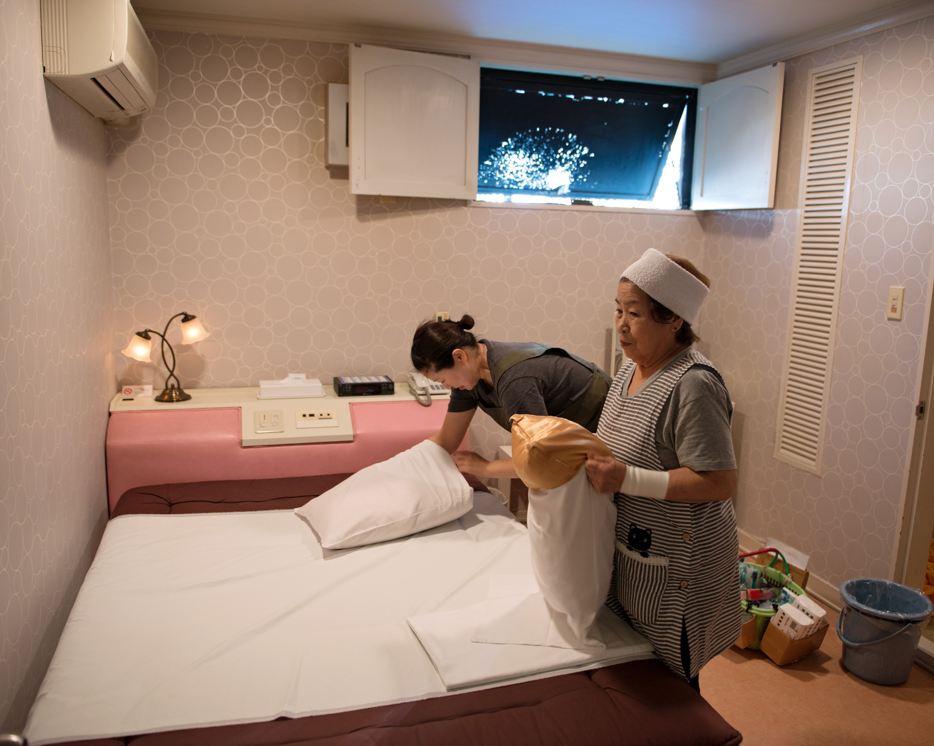 cleaning staff working in a room in the Hotel Fifteen Love, a love hotel, in Tokyo, Japan