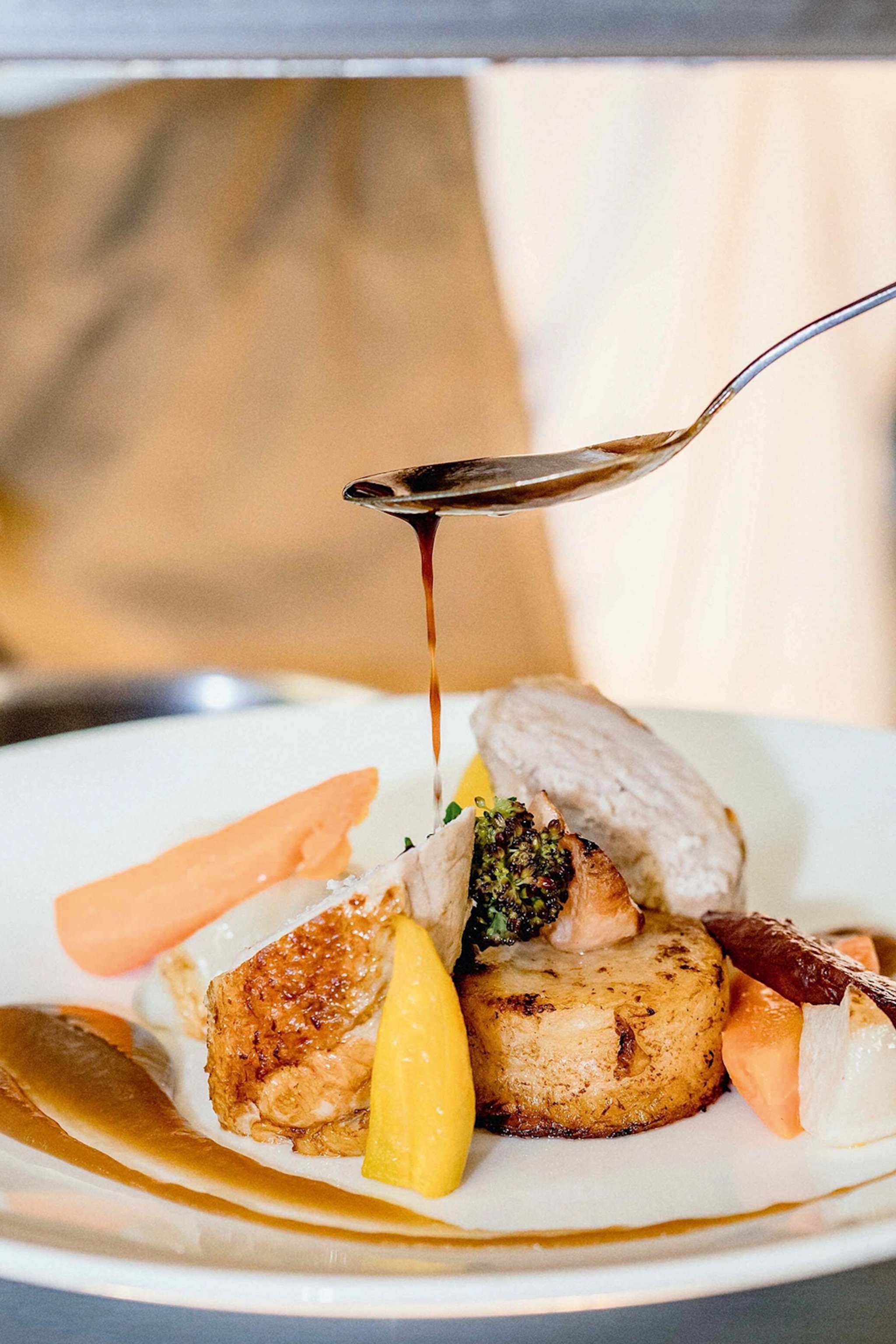 Plate of Guinea Fowl with sauce dripping off of it.