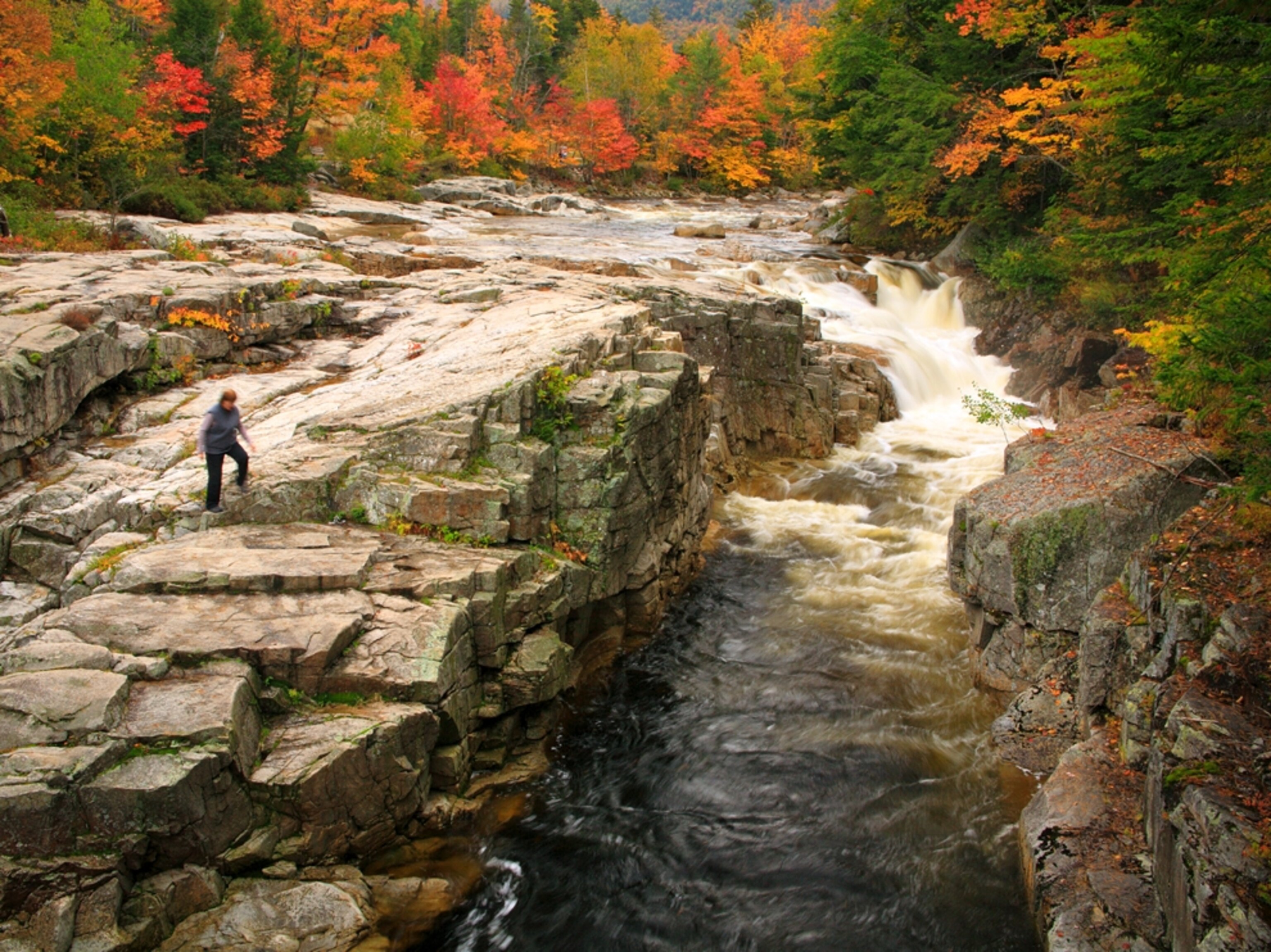 Woman walking at Rocky Gorge in the White Mountains in New Hampshire