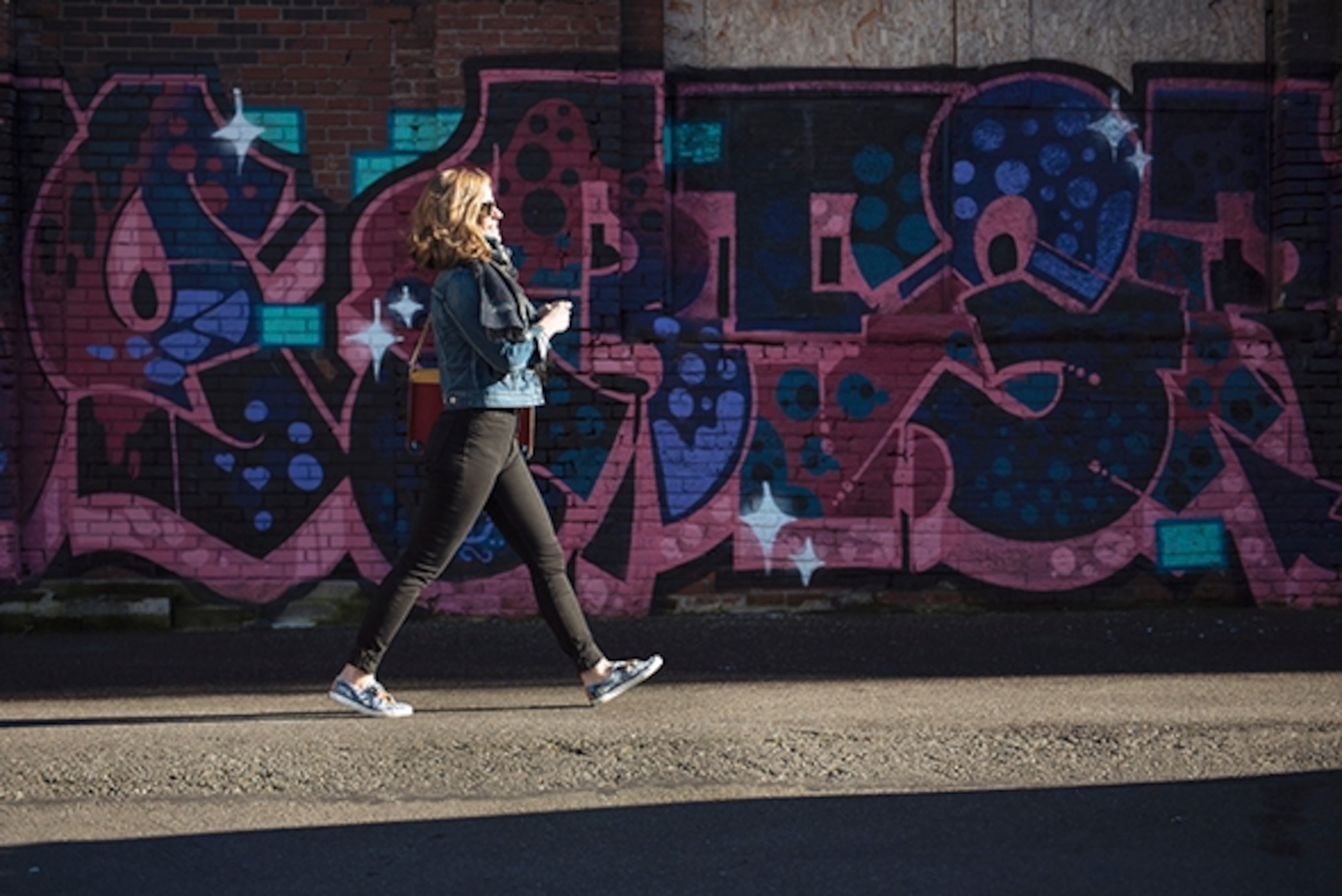 Maggie Tweedy walks along back alleys in downtown Seattle; Photograph by Max Lowe