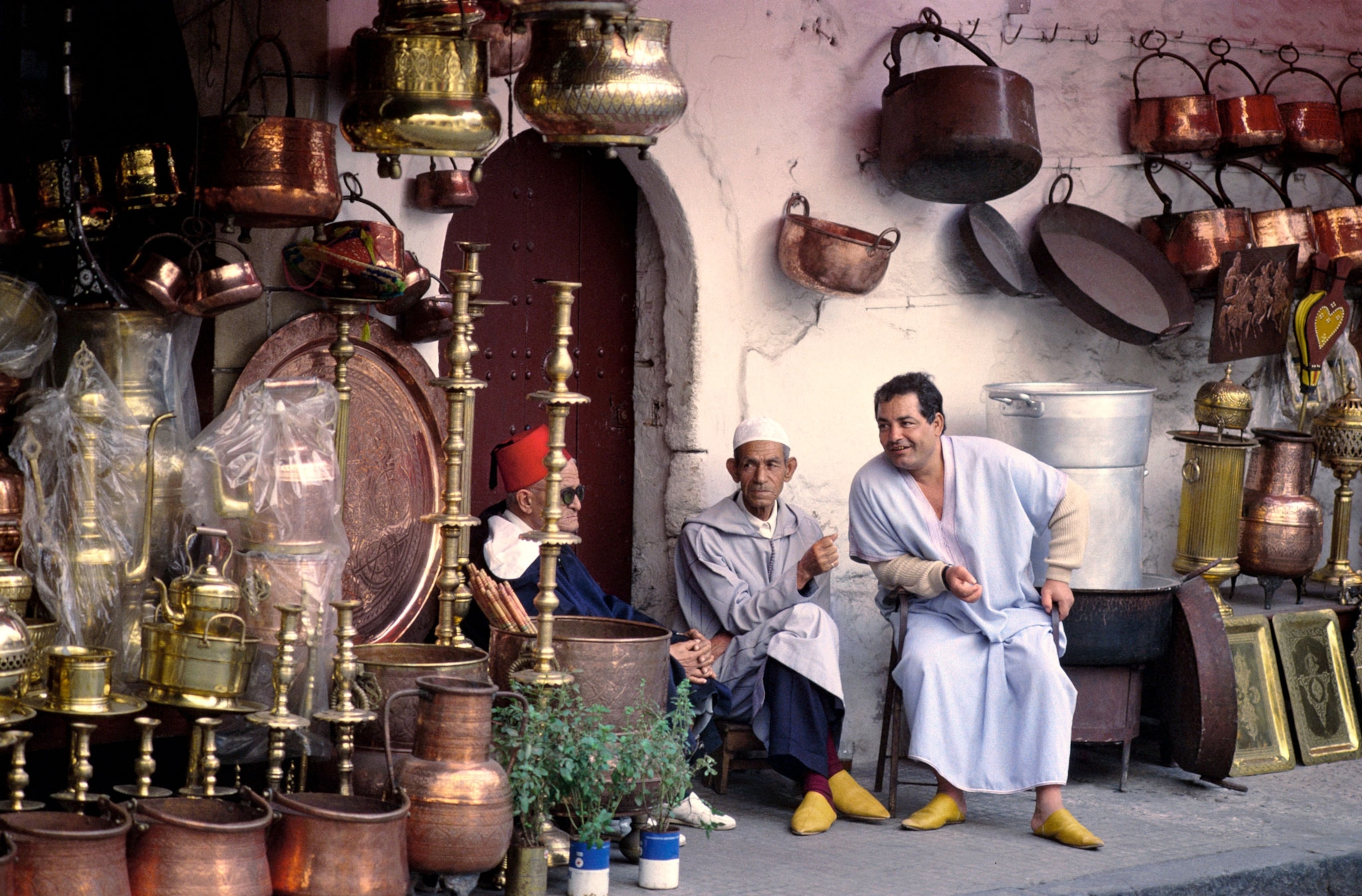 Morocco, Casablanca, street vendors, surrounded by copper goods