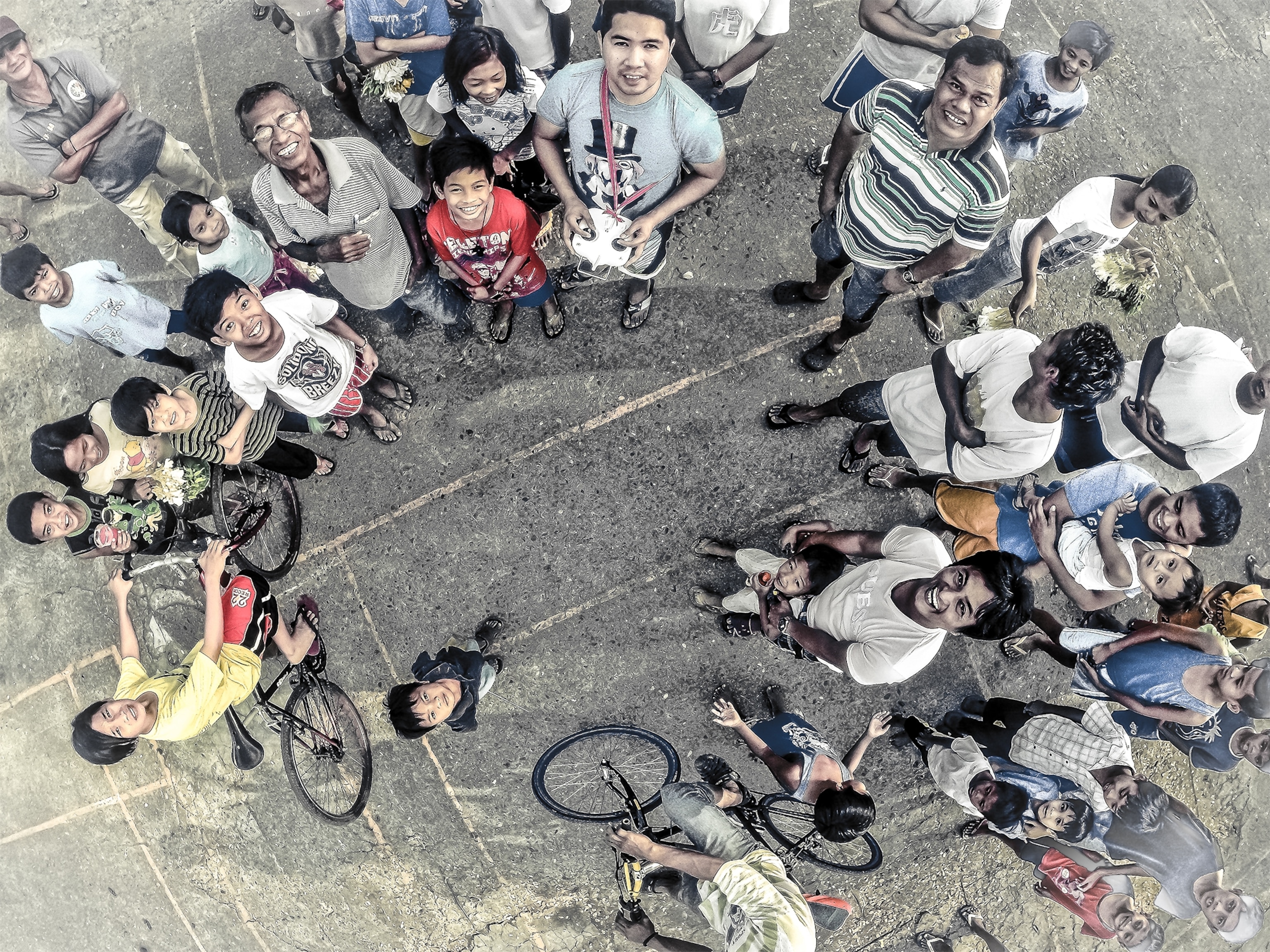 An aerial photo of people standing below a drone camera in Manila, Philippines.