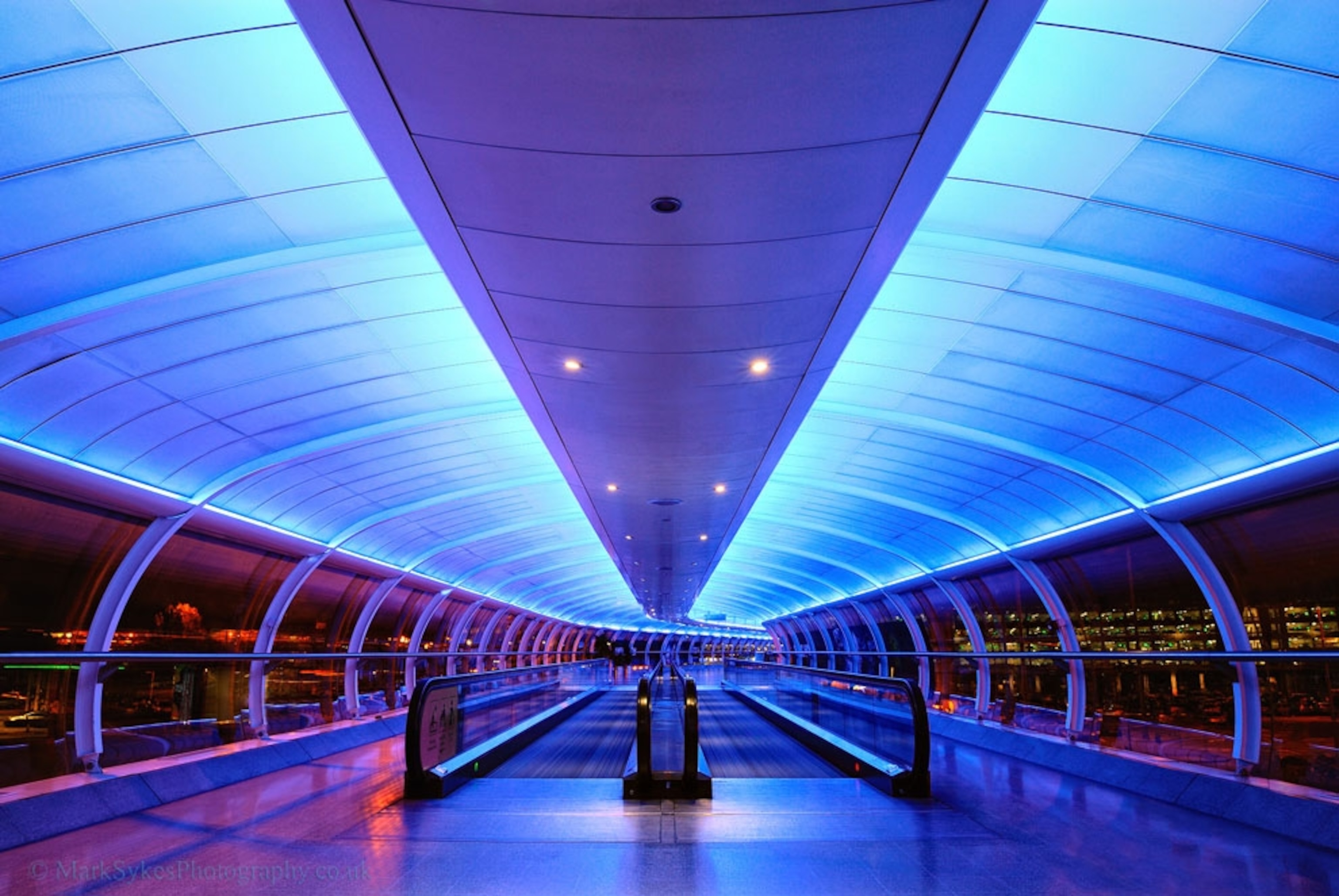Neon lights above an escalator