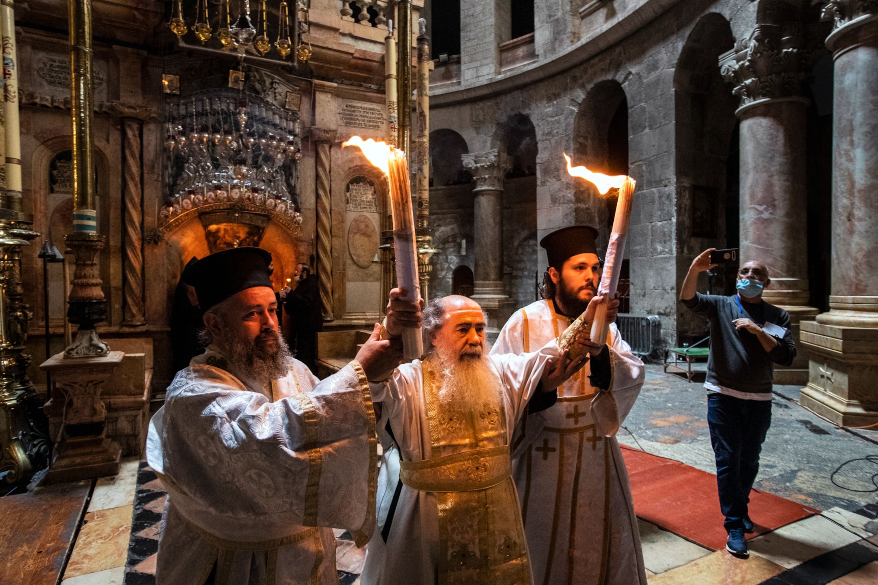 a Greek Orthodox priest conducting the Holy Fire Ceremony in Jerusalem