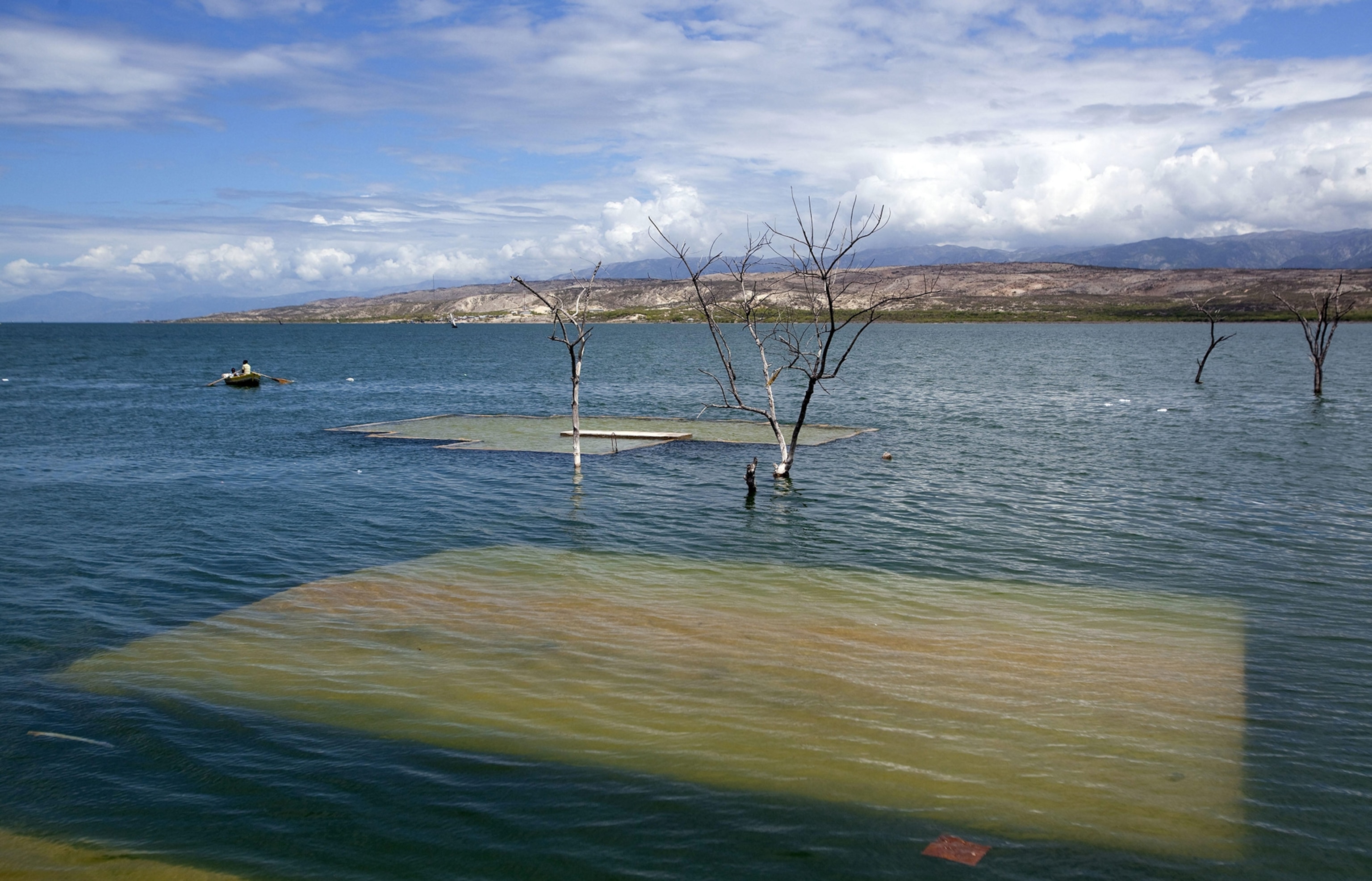 fisherman pass by the former migration and customs offices in Jimani, Dominican Republic